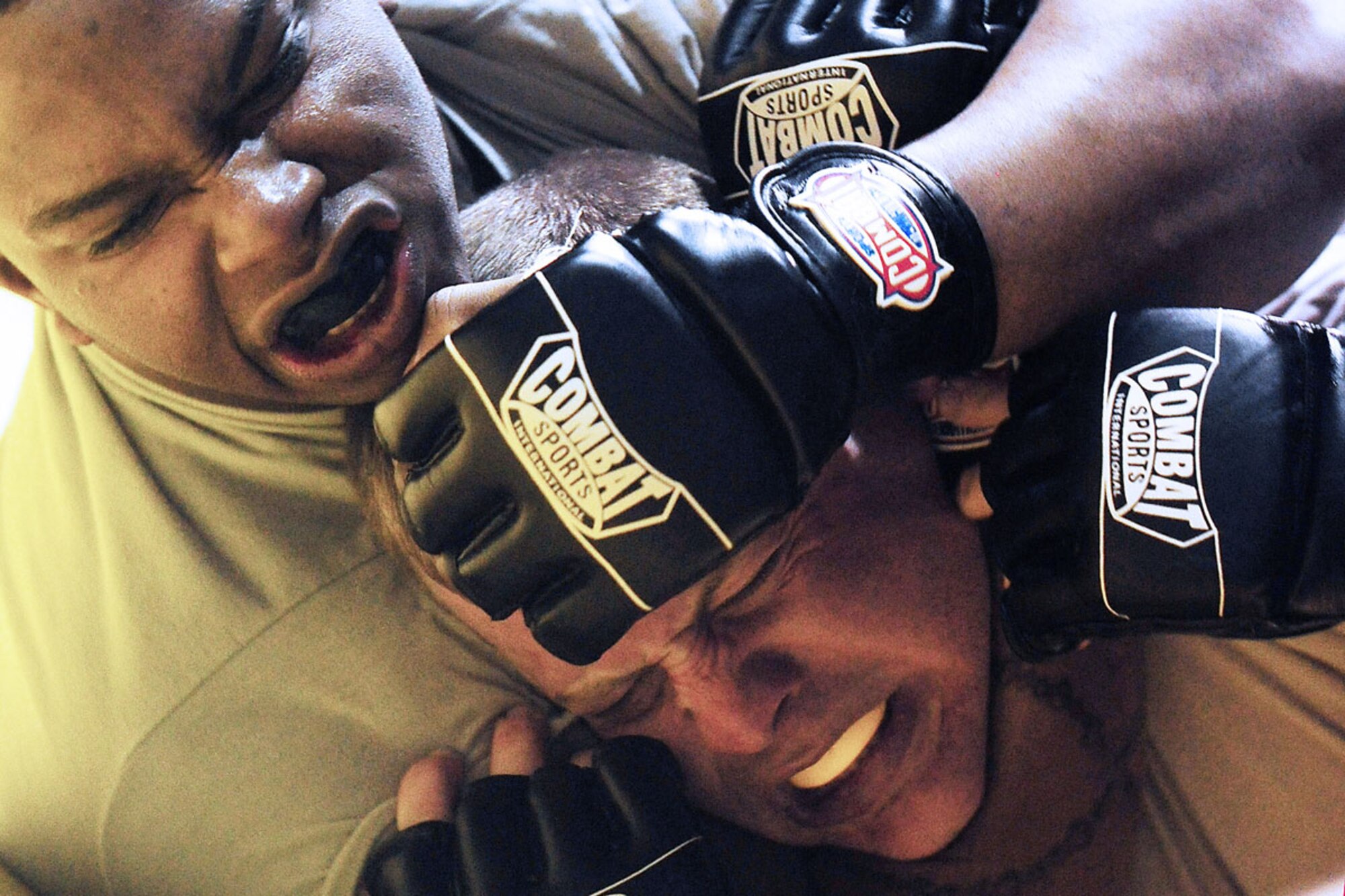 Spc. Shane Van Dyke, assigned to C Company, 1st Battalion, 5th Infantry Regiment, left, chokes Army 1st Lt. Tavis Reid, assigned to Fort Wainwright’s 73d Engineer  Company, during U.S. Army Alaska’s 2013 Combatives Tournament. (U.S. Air Force photo/Justin Connaher)