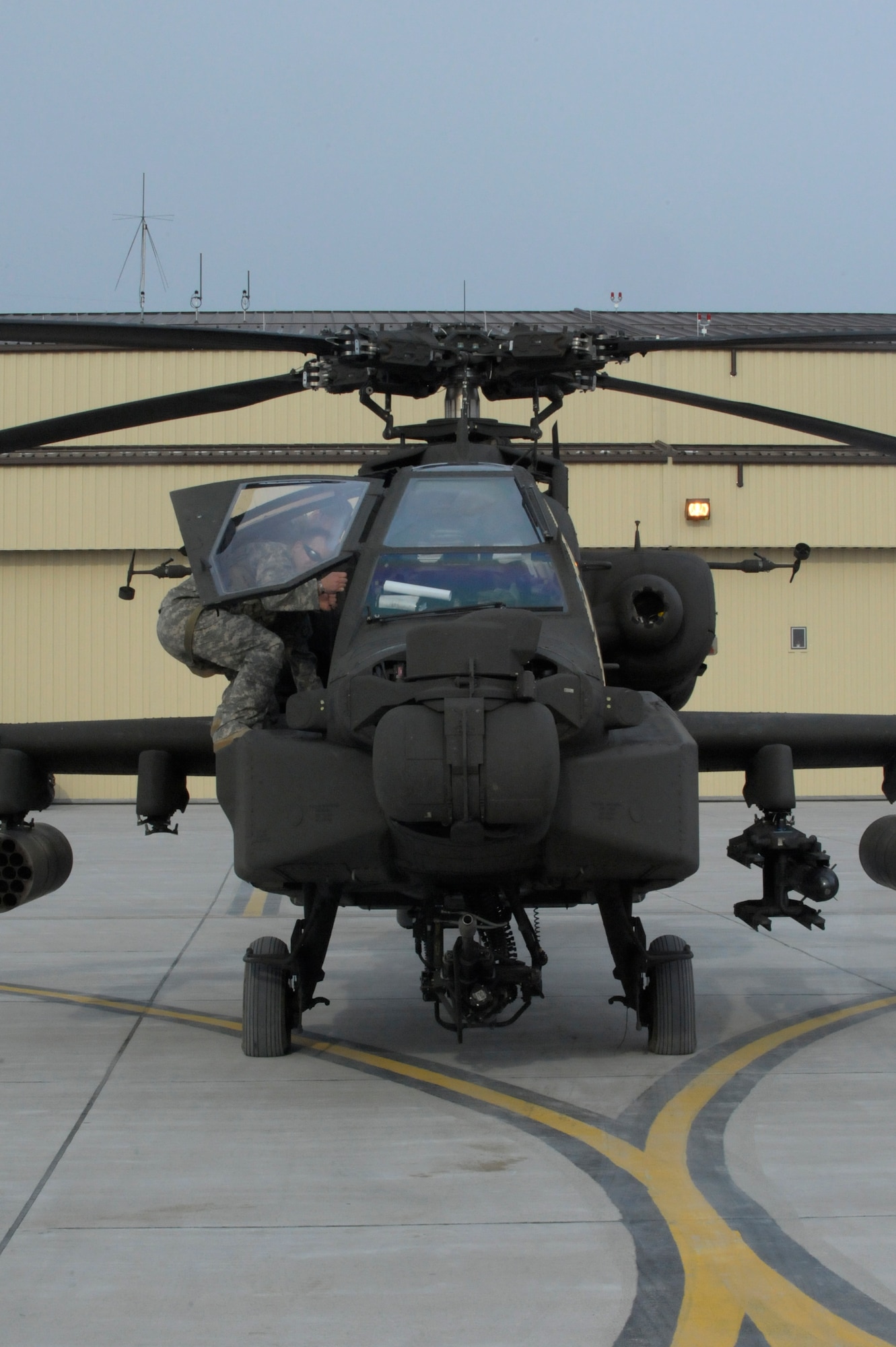 A U.S. Army AH-64 Apache Longbow crew chief from the 1-135th Attack Reconnaissance Battalion at Whiteman Air Force Base, Mo., prepares his aircraft March 27, 2013, for its deployment to Afghanistan. The 1-135th ARB has been working closely with Airmen on Whiteman AFB to prepare for the deployment. (U.S. Air Force photo by Airman 1st Class Shelby R. Orozco/Released)