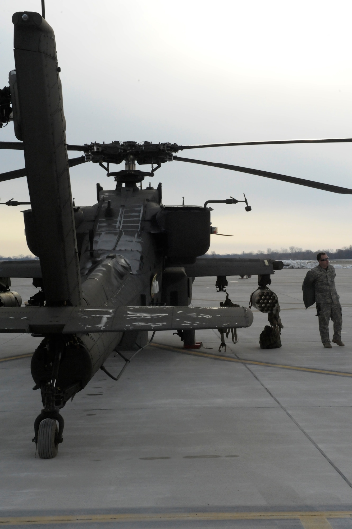 A U.S. Army AH-64 Apache Longbow crew chief from the 1-135th Attack Reconnaissance Battalion at Whiteman Air Force Base, Mo., prepares his aircraft March 27, 2013, for its deployment to Afghanistan. The 1-135th ARB will be working primarily with combat operations. (U.S. Air Force photo by Airman 1st Class Shelby R. Orozco/Released)