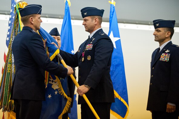 JOINT BASE ELMENDORF-RICHARDSON, Alaska -- U.S. Air Force Col. Dirk D. Smith, 3d Wing Commander, turned over the 3d Wing colors to  Lt. Gen. Stephen L. Hoog, Commander, Alaskan Command, U.S. Pacific Command; Commander, 11th Air Force, Pacific Air Forces; and Commander, Alaskan North American Aerospace Defense Commmand Region, Joint Base Elmendorf-Richardson, Alaska, during the 3d Wing Change of Command Ceremony held in Hangar 1, Wednesday, Mar. 20, 2013. Col David S. Nahom, far right, awaits to take command of the 3d Wing. (US Air Force photo by Johnathon Green)
