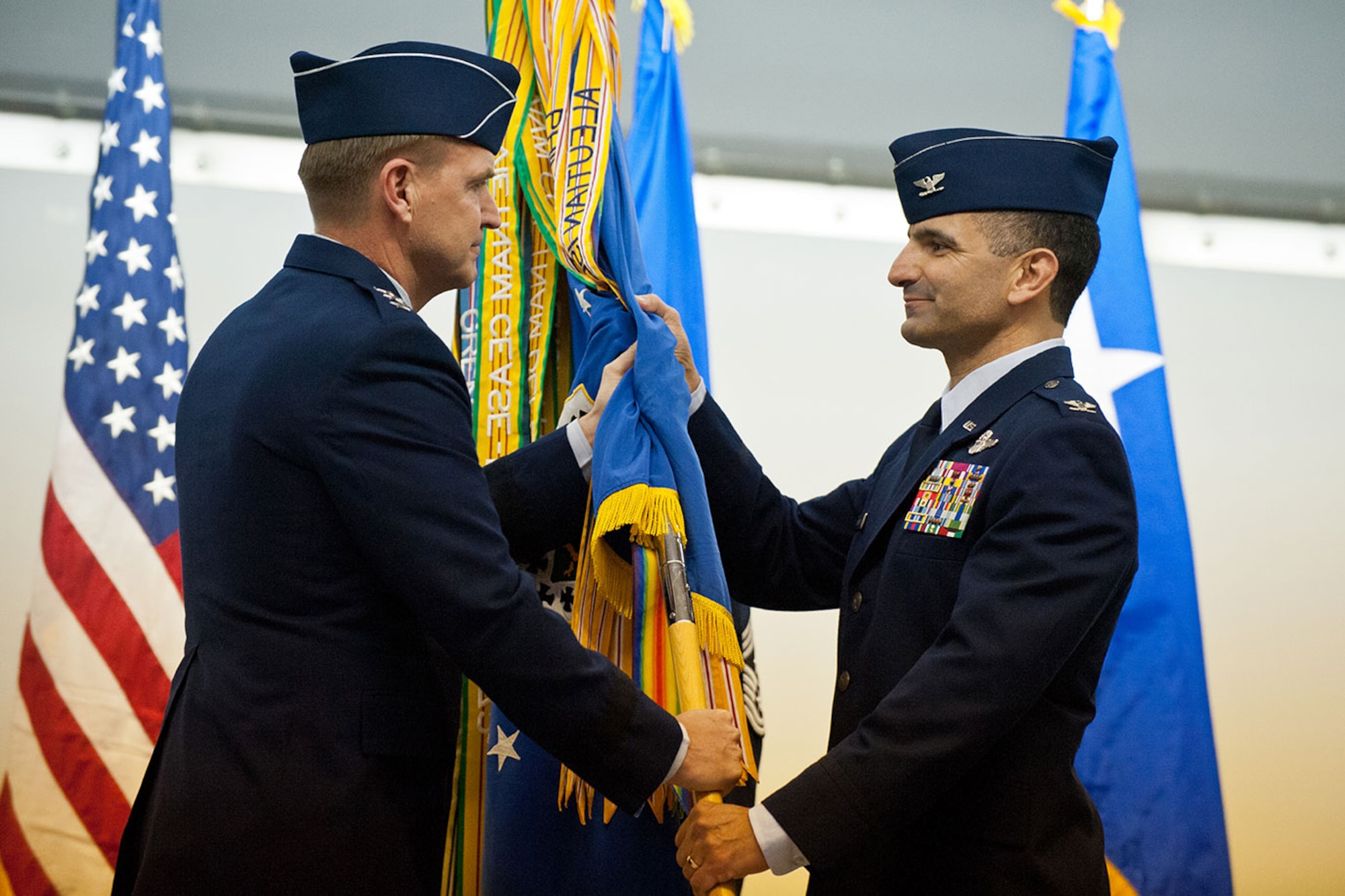JOINT BASE ELMENDORF-RICHARDSON, Alaska --  Lt. Gen. Stephen L. Hoog, Commander, Alaskan Command, U.S. Pacific Command; Commander, 11th Air Force, Pacific Air Forces; and Commander, Alaskan North American Aerospace Defense Commmand Region, Joint Base Elmendorf-Richardson, Alaska, presents the 3d Wing colors to Col. David S. Nahom, the new 3d Wing Commander, Wednesday, Mar. 20, 2013, at the 3d Wing Change of Command Ceremony in Hangar 1. (US Air Force photo by Johnathon Green)