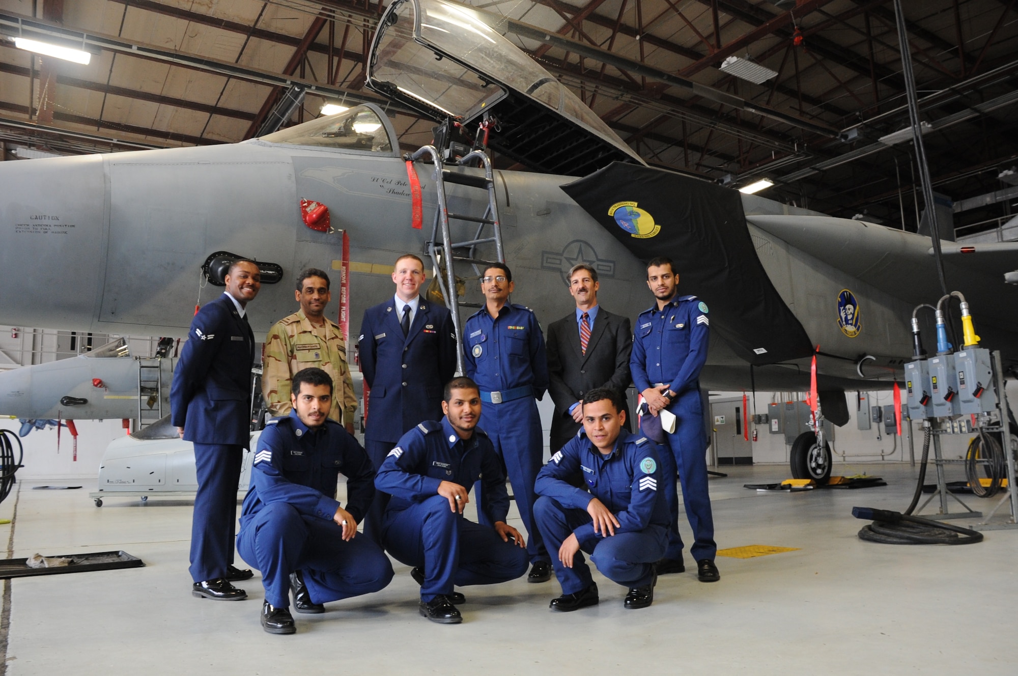 Royal saudi air force students stand in front of an F-15 jet with their instructor, Steven Canham, in a maintnance hangar March 22, 2013. These Saudi students were the first to graduate from an F-15 avionics course at Sheppard. (U.S. Air Force photo by Airman 1st Class Jelani Gibson)
