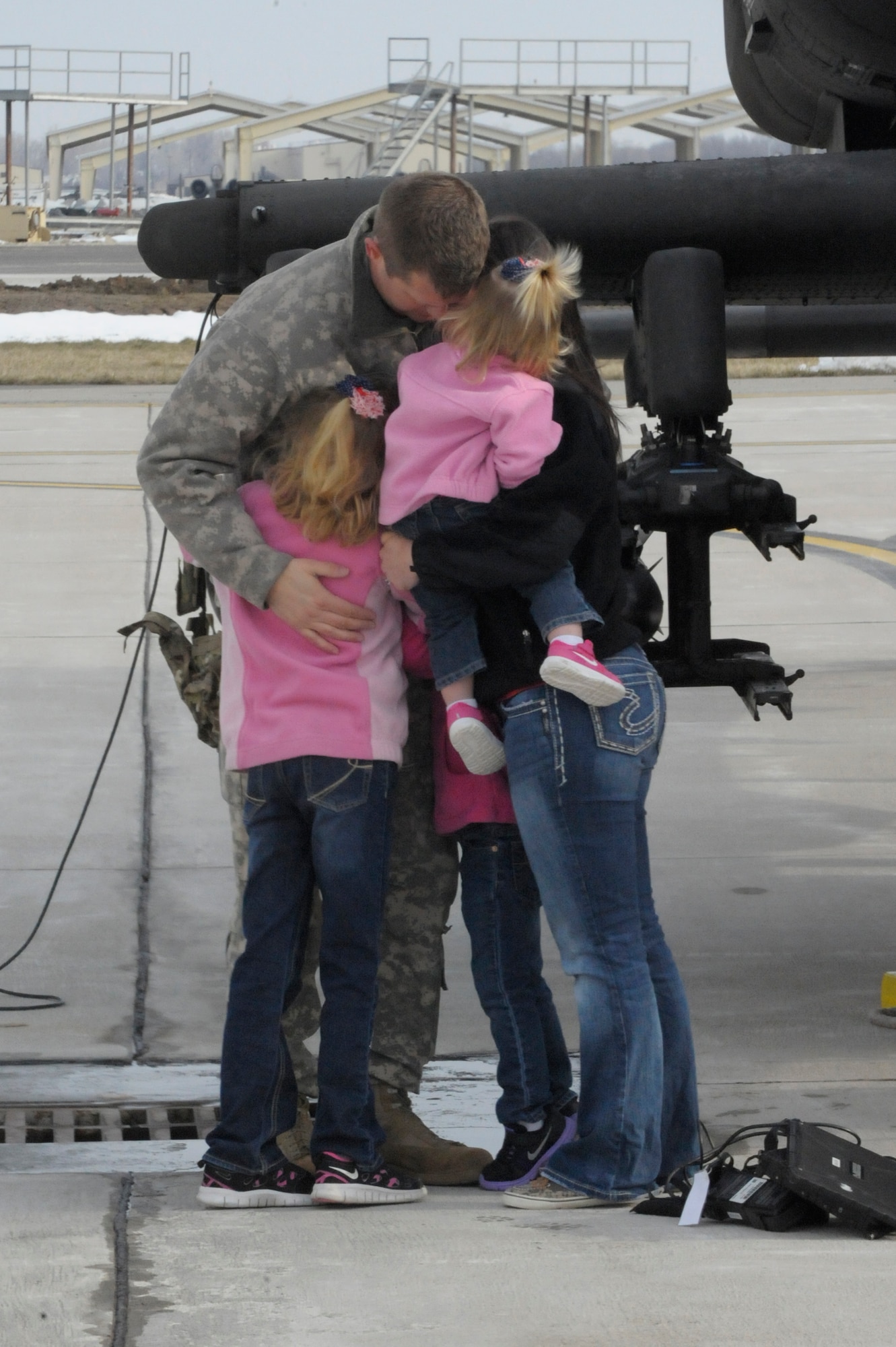 U.S. Army Chief Warrant Officer 3 Marcus Moore with the 1-135th Attack Reconnaissance Battalion at Whiteman Air Force Base, Mo., says goodbye to his family March 27, 2013, before his deployment to Afghanistan. Moore and his counterparts will be deployed for more than a year. (U.S. Air Force photo by Airman 1st Class Shelby R. Orozco/Released)