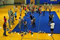 Professional Ultimate Fighting Championship fi ghters teach sparring techniques during the UFC Demo Event March 15 at Joint Base San Antonio- Randolph's Rambler Fitness Center. (U.S. Air Force photo by Airman 1st Class Colville McFee/ Released)