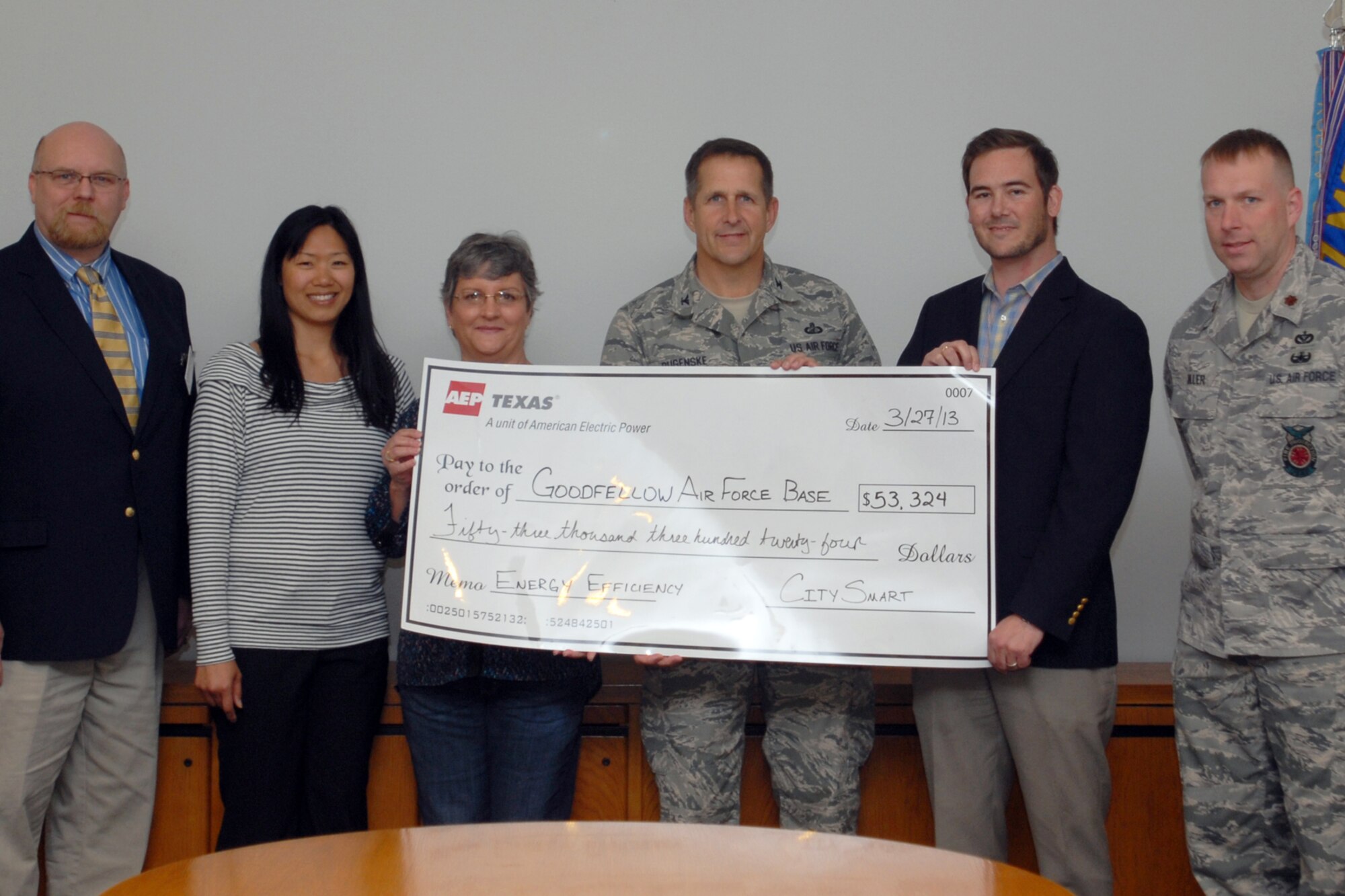 GOODFELLOW AIR FORCE BASE, Texas – (left) Gary Throckmorton, America Electric Power program coordinator, Grace Hsieh, AEP CitySmart program specialist, Mary Lumsdon, base energy manager and recipient of the check, Col. Paul Bugenske, 17th Mission Support Group Commander, Matthew Romero AEP program manager, and Maj. Kurt Muller, 17th Civil Engineer Squadron Commander stand holding a check from the AEP CitySmart program March 27 at the Civil Engineers building here. The CitySmart program provides governmental agencies monetary incentives to implement energy saving projects in existing and new facilities. (U.S. Air Force photo/ Airman 1st Breonna Fields)

