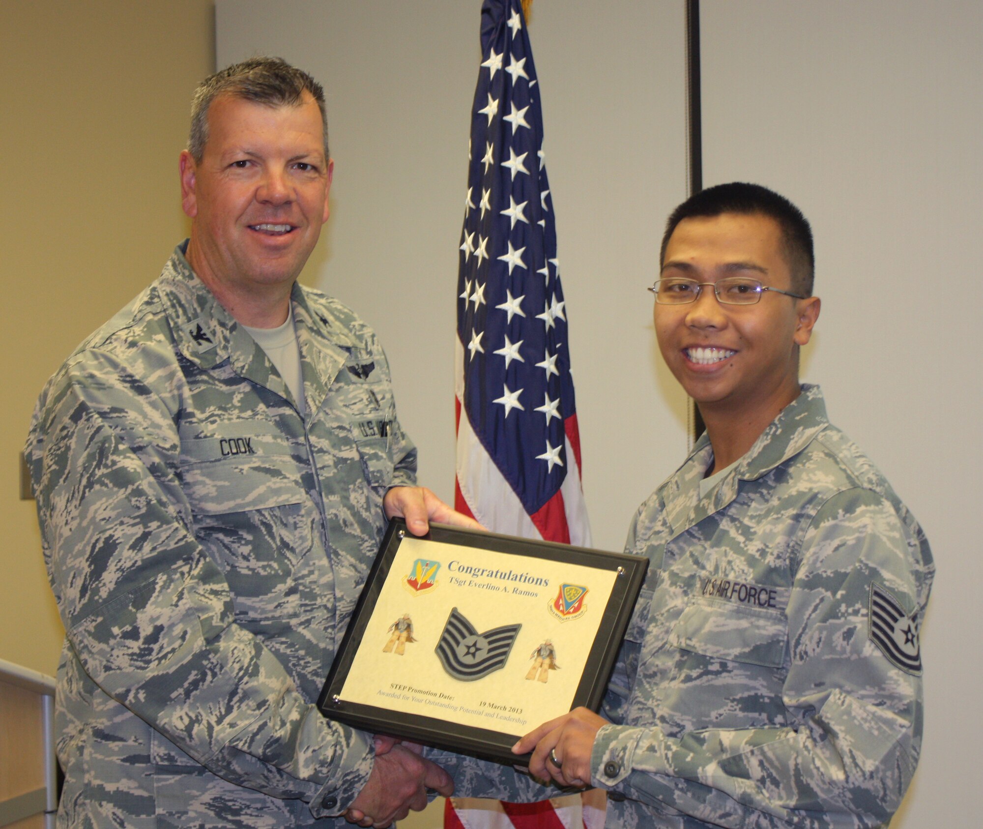U.S. Air Force Col. Timothy Cook, 366th Medical Group deputy commander, presents a promotion certificate to Tech. Sgt. Everlino Ramos, 366th Medical Support Squadron lab technician, March 20, 2013, at Mountain Home Air Force Base, Idaho. Ramos was instantly promoted through the Stripes for Exceptional Performers program, more commonly known as a STEP promotion. (U.S. Air Force photo/Senior Airman Lance Courtier)


