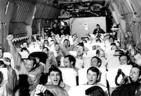 Newly freed American prisoners of war celebrate as their C-141A aircraft lifts off from Hanoi, North Vietnam, Feb. 12, 1973, during Operation Homecoming. (Courtesy photo)