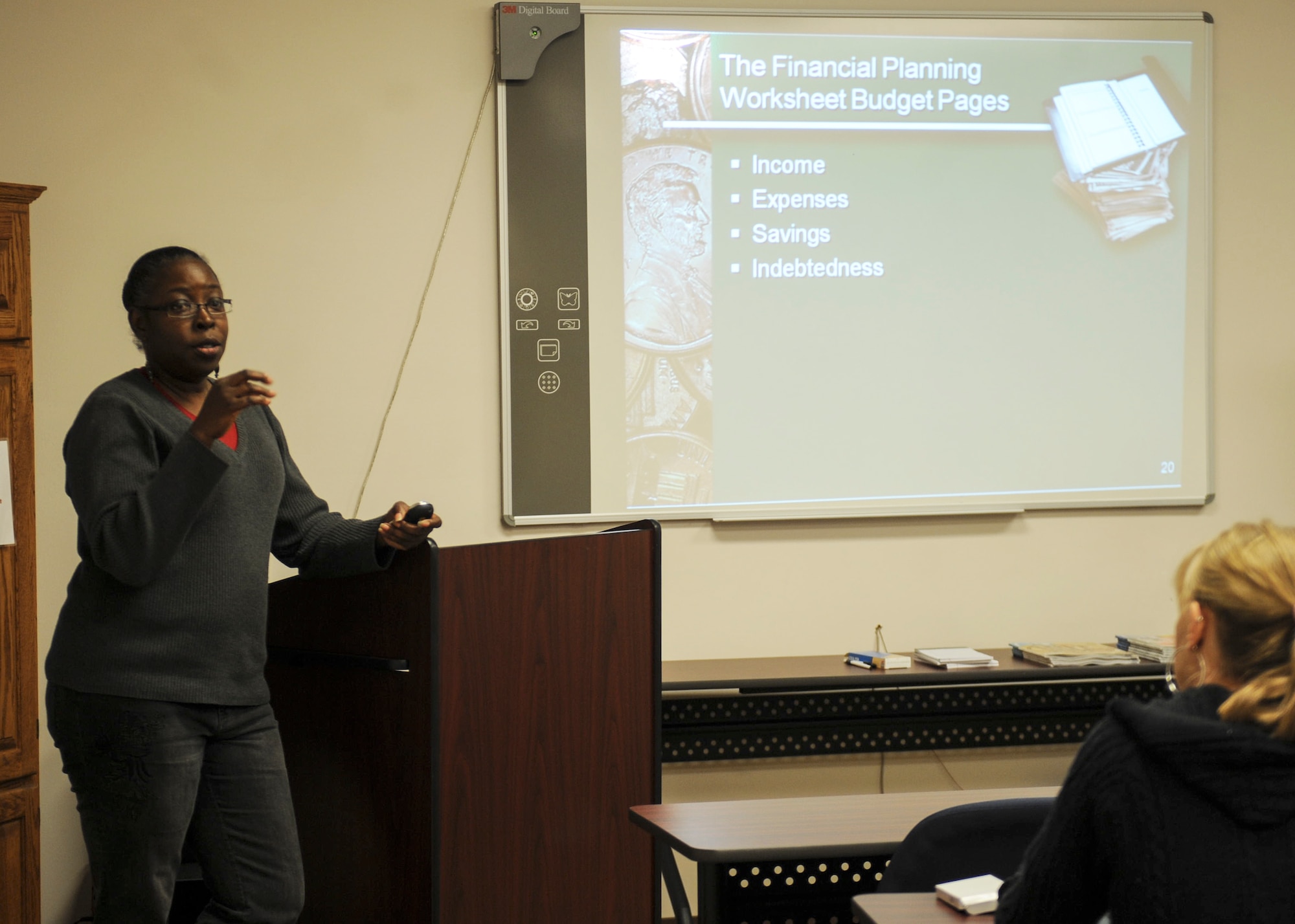 Sharon Register, 23d Force Support Squadron community readiness consultant, teaches the Financial Lunch and Learn in the Airman and Family Readiness Center at Moody Air Force Base, Ga., March 21, 2013. Register advised students to decipher their wants versus needs when it comes to spending. (U.S. Air Force photo by Airman 1st Class Olivia Bumpers/Released)