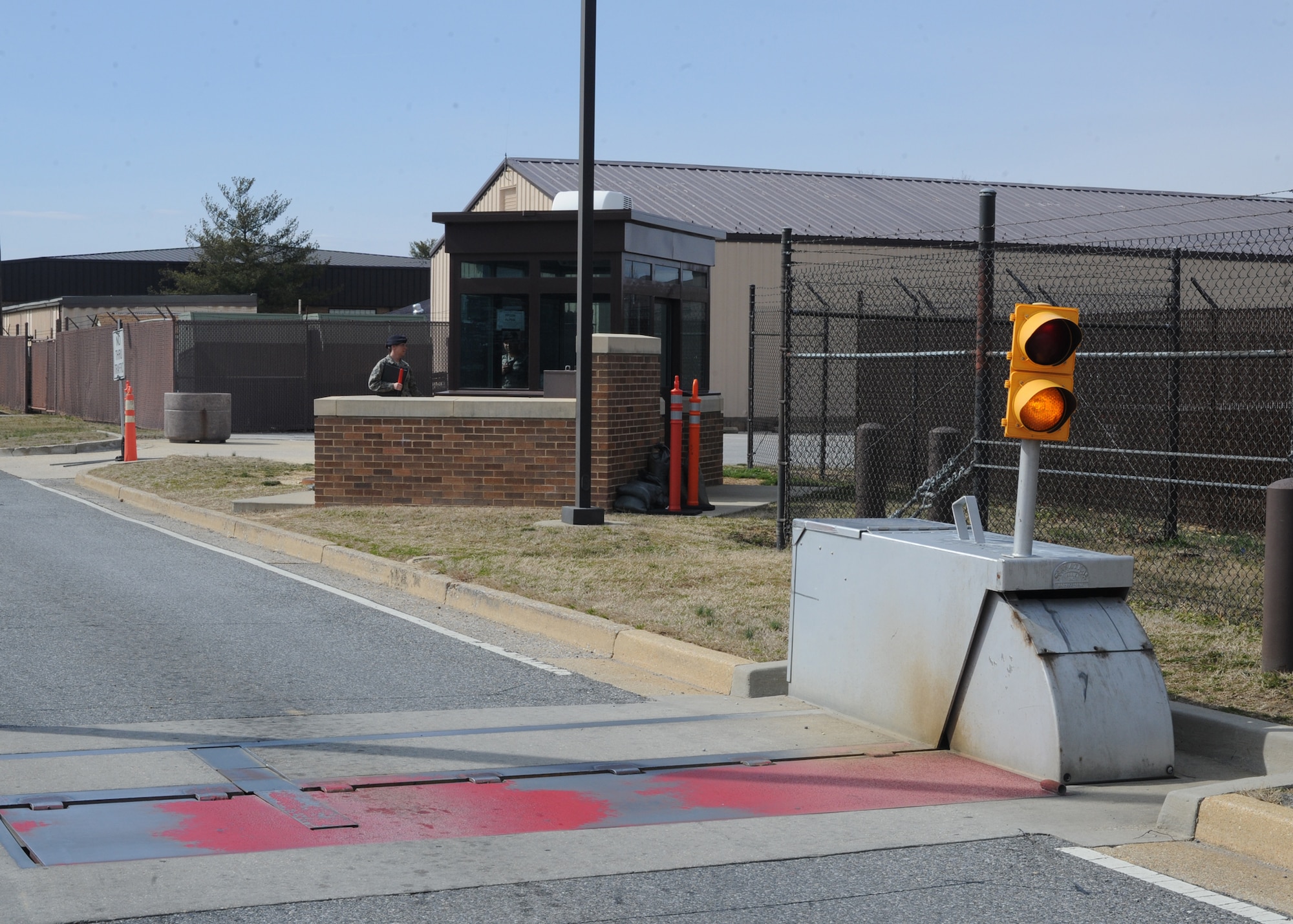The active vehicle barrier system, or pop-up barrier, is designed to physically prevent unauthorized vehicles from entering Joint Base Andrews.  The pop-up barriers are hydraulic, manually operated, systems that deploy in just over one second.  As a safety feature, there are light systems immediately next to each barrier.  These lights flash yellow when the barriers are completely down.  When you see the flashing yellow light, proceed with caution at a reduced speed.  

If the light is red, stop immediately!  The steady red light means the pop-up barrier has been activated.  DO NOT PROCEED.  Wait until the light returns to a yellow flashing before proceeding.  

If stopped at a light, DO NOT STOP ON THE BARRIER SYSTEM.  These barriers deploy with enough force to lift your vehicle off the ground.  

Please contact the Antiterrorism Office at 240-612-6313 with any questions or for additional information.  We look forward to protecting you, while together we defend America.
