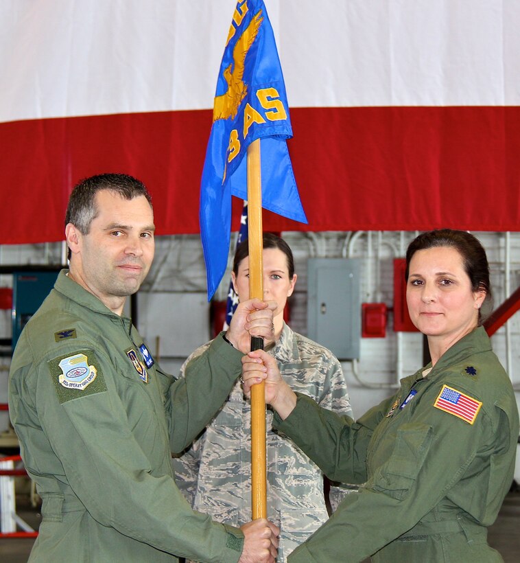 Col. Karl Goerke, commander, 932nd Operations Group, presents the unit guidon to Lt. Col. Marlena Parker, new commander of the 73rd Airlift Squadron.  The assumption of command ceremony was held March 9, 2013 in Hangar One at Scott Air Force Base. Lt. Col. Paul Brown, was the previous  73rd AS commander.  The 932nd Airlift Wing is an Air Force Reserve unit that flies the C-40C. (U.S. Air Force photo/Tech. Sgt. Viveka Ferrell)
