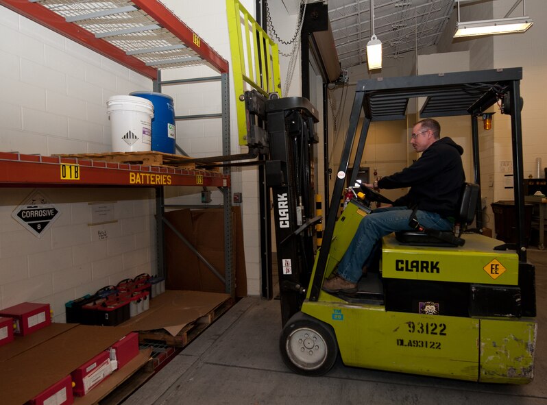 Ed Betz, Chenega Global Services, LLC hazardous material environmental technician, stores hazardous material at the consolidated accumulation point on Ellsworth Air Force Base, S.D., March 22, 2013. HAZMART provides a single point of control for management, accountability and tracking of the distribution and use of all hazardous materials on the base. (U.S. Air Force photo by Airman 1st Class Alystria Maurer/Released)