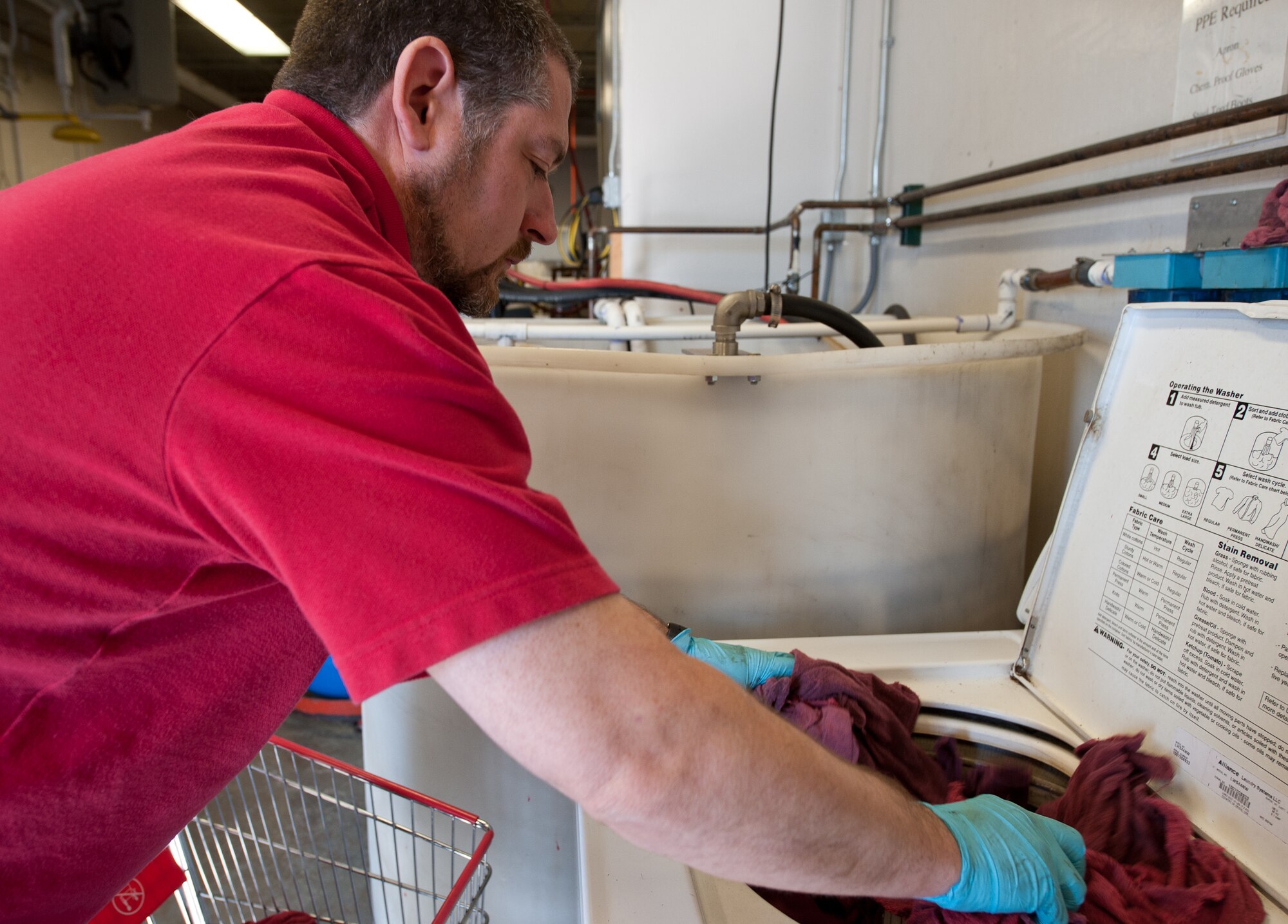 Eric McCarty, Chenega Global Services, LLC hazardous material environmental technician, washes contaminated rags at Ellsworth Air Force Base, S.D., March 22, 2013. HAZMART consists of 4 functional areas: control and management, regulated distribution, material reuse and recycling, and reduction of hazardous waste to track and control all hazardous material on the base. (U.S. Air Force photo by Airman 1st Class Alystria Maurer/Released)