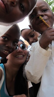 1st Lt. Diana Wong, bottom, assigned to the 509th Force Support Squadron at Whiteman Air Force Base, Mo., gets to know school children in Tanzania, Feb. 16, 2013. After reaching the summit of Mount Kilimanjaro, she spent time exploring the local communities. (Courtesy photo/Released)