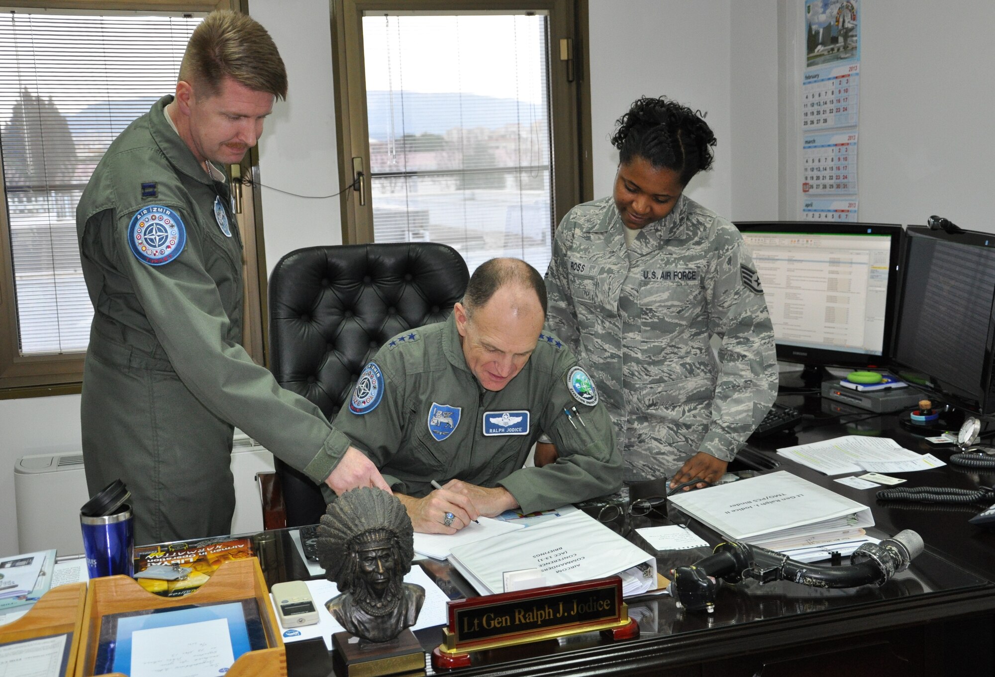 Capt. Michael Alblinger, Air Force Assistance Fund campaign representative for NATO, and Staff Sgt. Ieschia Ross, AFAF campaign representative for the 425th Air Base Squadron, brief Lt. Gen. Ralph Jodice II, NATO Headquarters Allied Air Command Izmir commander, about the AFAF campaign details March 25, 2013, at NATO in Izmir, Turkey. The four major organizations which receive contributions from the AFAF are the Air Force Villages, the Air Force Aid Society, the General and Mrs. Curtis E. LeMay Foundation, and the Air Force Enlisted Village. (U.S. Air Force photo byTanju Varlikli/Released)