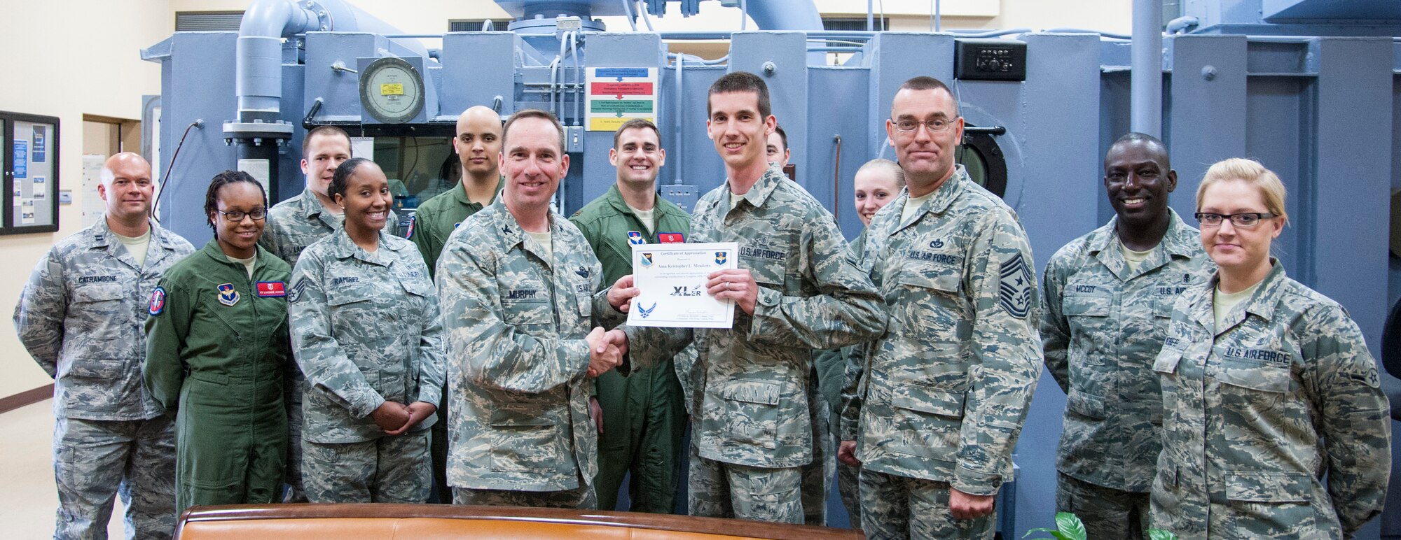 Airman Kristopher L. Meadows, 47th Medical Operations Squadron aerospace physiology, poses with Col. Tom Murphy, 47th Flying Training Wing commander, after being presented the XLer of the week award at Laughlin Air Force Base, Texas, March 7, 2013. The XLer is a weekly award chosen by wing leadership and given to those who consistently make outstanding contributions to Laughlin and their unit. (U.S. Air Force photo/Senior Airman Nathan Maysonet)
