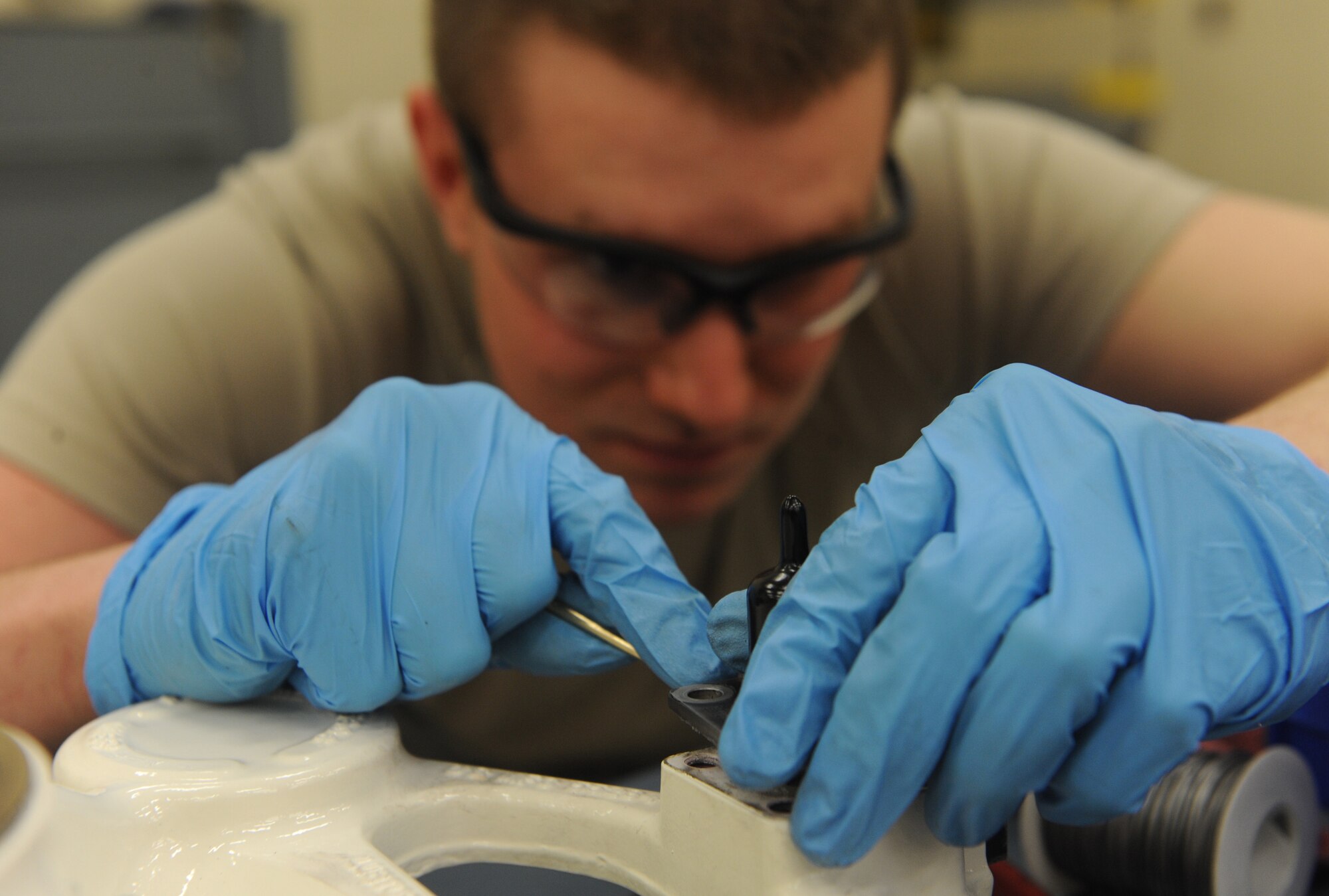 Senior Airman Travis Dowler, 509th Maintenance Squadron hydraulic systems repair technician, attaches a half-gear coupling to a B-2 Spirit brake system at Whiteman Air Force Base, Mo., March 22, 2013. The hydraulic shop performs all maintenance for the hydraulic systems on both the B-2 and the T-38 Talon. (U.S. Air Force photo by Airman 1st Class Bryan Crane/Released)