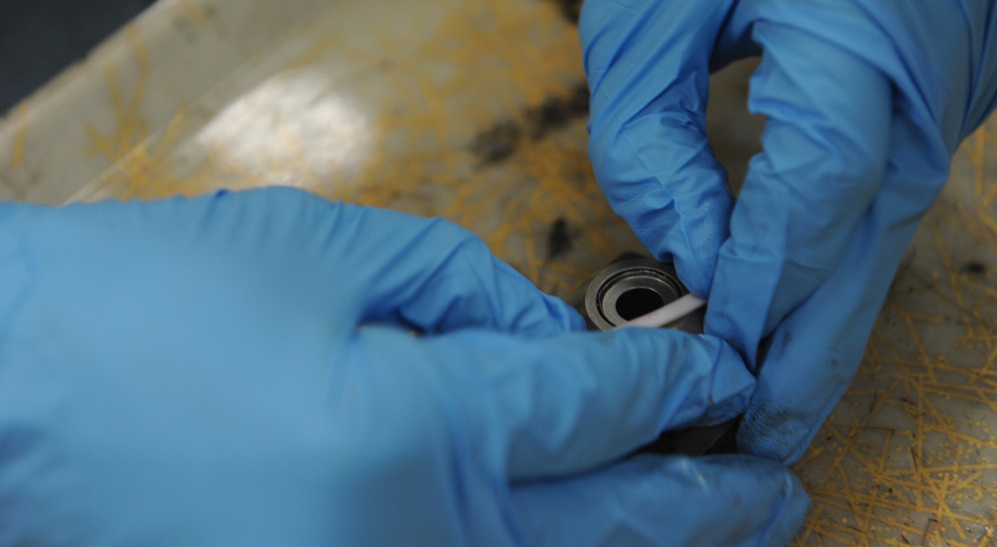 Senior Airman Travis Dowler, 509th Maintenance Squadron hydraulic systems repair technician, seals off a half-gear coupling at Whiteman Air Force Base, Mo., March 22, 2013. A half-gear coupling is a part used for the B-2 Spirit brake structure. (U.S. Air Force photo by Airman 1st Class Bryan Crane/Released)