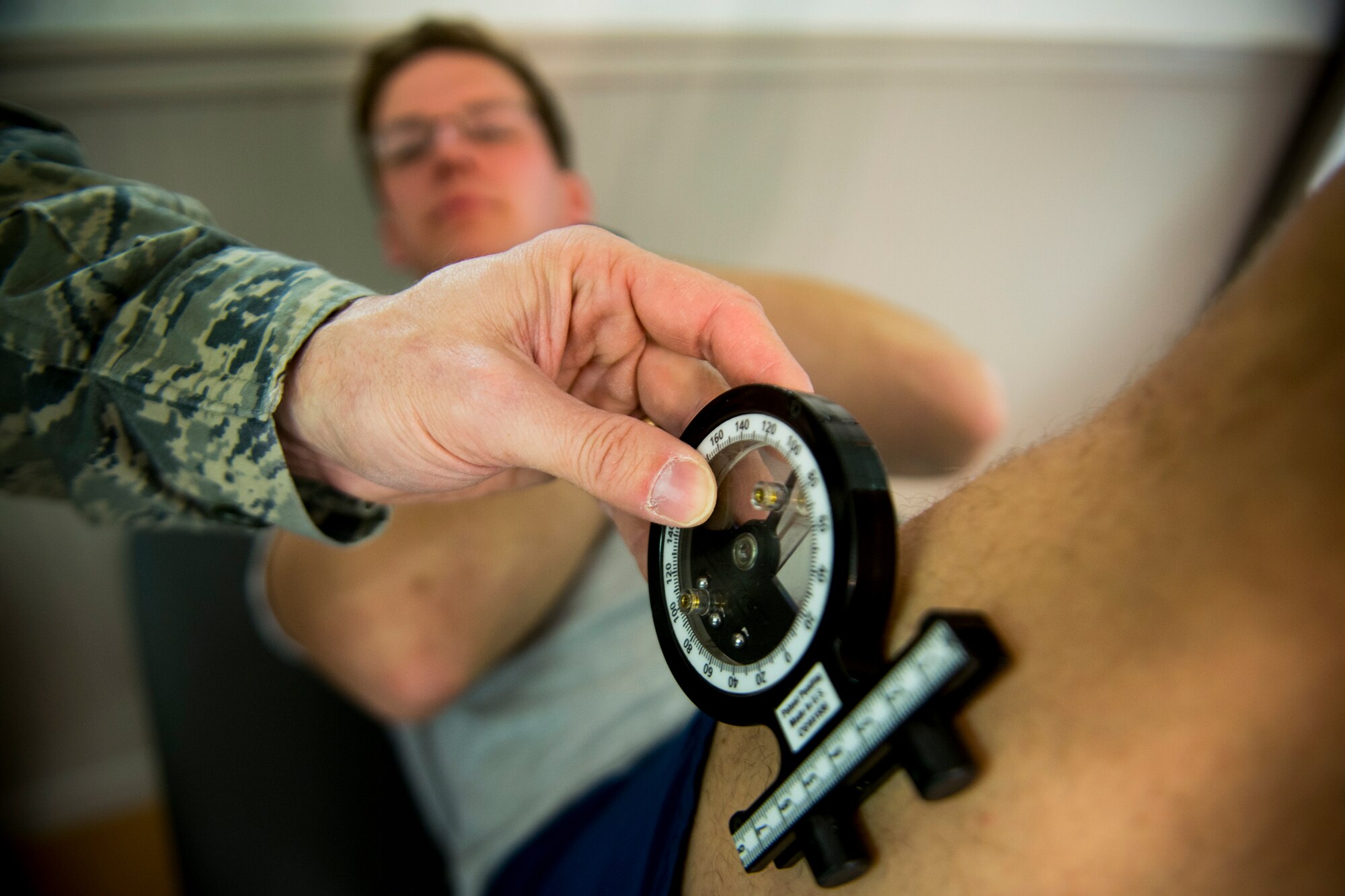 U.S. Air Force Maj. Jon Wilson, 93d Air Ground Operations Wing director of human performance, conducts a double-leg lowering test to Airman 1st Class Fedor Potanin, 823d Base Defense Squadron fireteam member, Jan. 9, 2013, at Moody Air Force Base, Ga. Double-leg lowering tests evaluate core strength and can help determine causes of poor posture or lower back pain. (U.S. Air Force photo by Staff Sgt. Jamal D. Sutter/Released) 