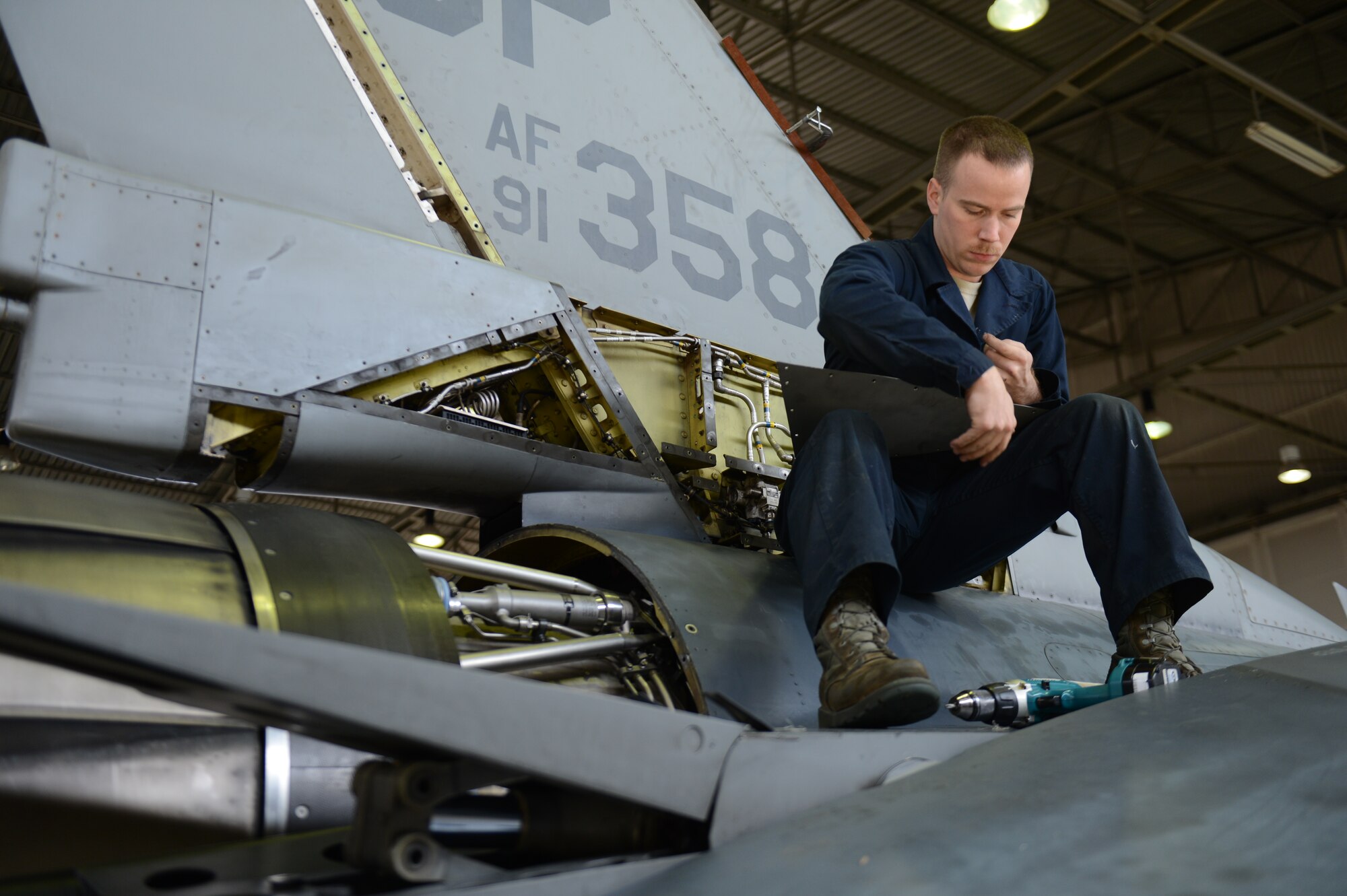 SPANGDAHLEM AIR BASE, Germany – U.S. Air Force Senior Airman Todd Hughes, 52nd Equipment Maintenance Squadron inspection team member from Williamsport, Pa., places rivets on a U.S. Air Force F-16 Fighting Falcon fighter aircraft panel March 27, 2013. Technicians remove the panels to reveal the aircraft’s internal workings prior to beginning an inspection. (U.S. Air Force photo by Airman 1st Class Gustavo Castillo/Released)