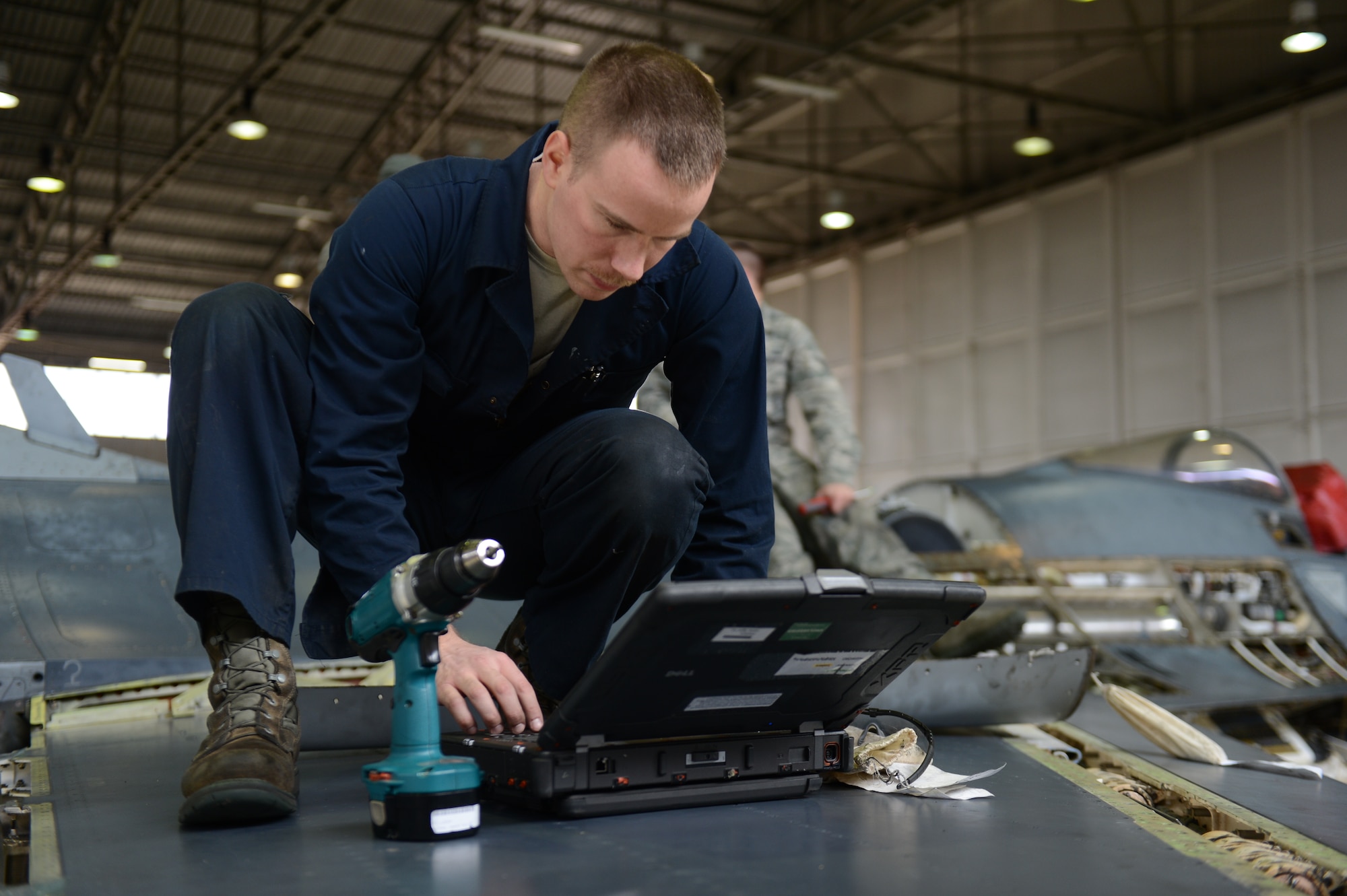 SPANGDAHLEM AIR BASE, Germany – U.S. Air Force Senior Airman Todd Hughes, 52nd Equipment Maintenance Squadron inspection team member from Williamsport, Pa., reviews instructions for replacing panels on a U.S. Air Force F-16 Fighting Falcon fighter aircraft March 27, 2013. U.S. Air Force guidelines require Hughes to review the instructions prior to performing maintenance to be sure the aircraft is safe for flight. (U.S. Air Force photo by Airman 1st Class Gustavo Castillo/Released)