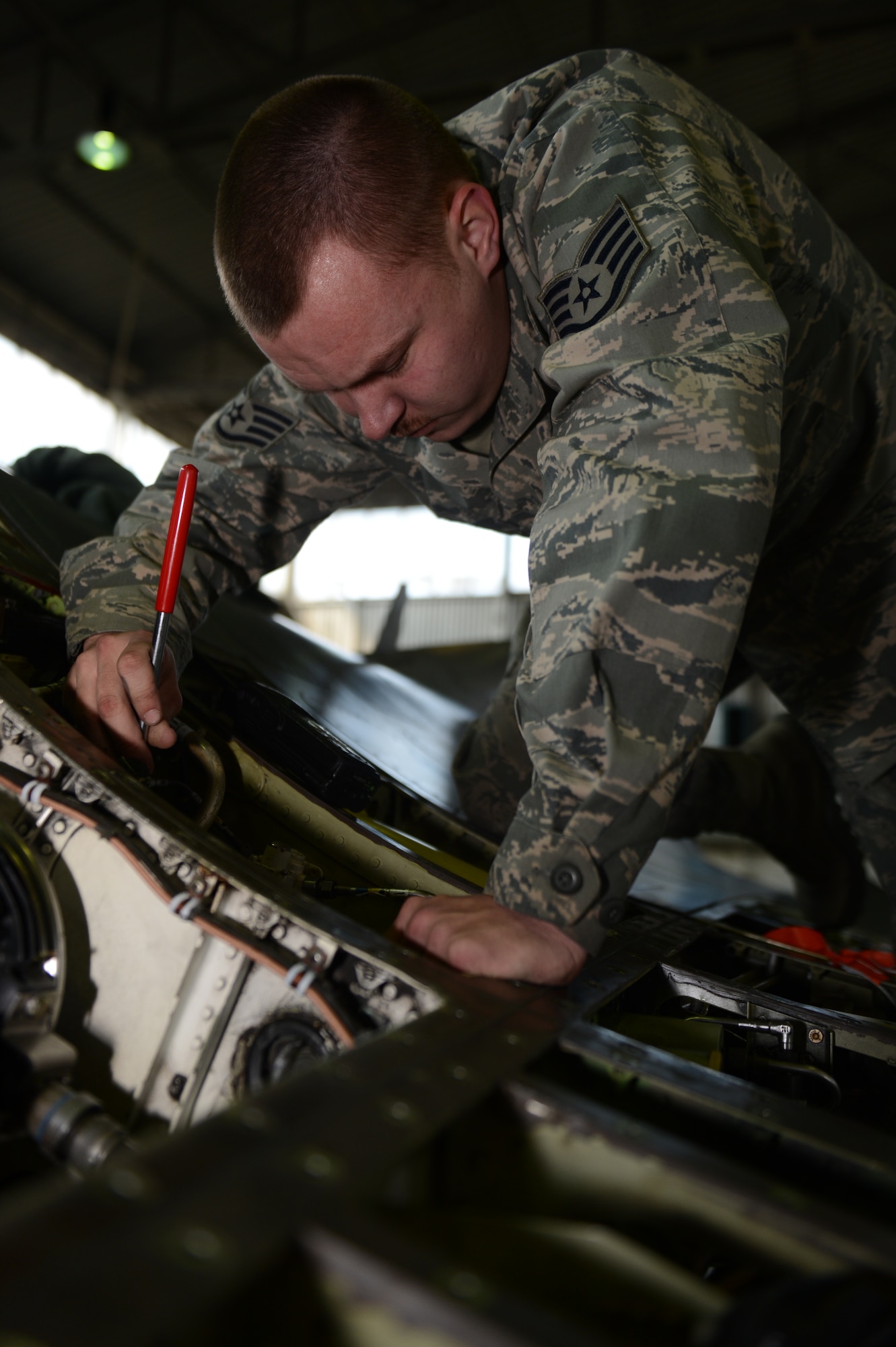 SPANGDAHLEM AIR BASE, Germany – U.S. Air Force Staff Sgt. Robert Arthur, 480th Aircraft Maintenance Unit weapons load crew team chief from Burgaw, N.C., uses a magnet to search for displaced metal fragments after replacing a weapon system on an U.S. Air Force F-16 Fighting Falcon fighter aircraft March 27, 2013. The weapon replacement takes place every 18 months to ensure all parts are clean and in working condition. Loose debris can damage the weapon system by jamming or destroying internal components. (U.S. Air Force photo by Airman 1st Class Gustavo Castillo/Released)