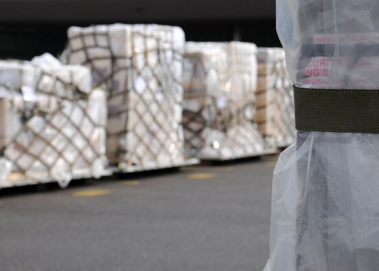 Pallets, covered in plastic to protect cargo against potential chemical attacks down-range, line the yard March 19, 2013, at RAF Mildenhall, England. Personnel from the 100th Logistics Readiness Squadron Air Transportation taught a class to 13 military members on how to safely build a pallet depending on the type of cargo and aircraft. They also educated the trainees on the documentation that must accompany a pallet to the cargo deployment function. (U.S. Air Force photo by Gina Randall/Released) 