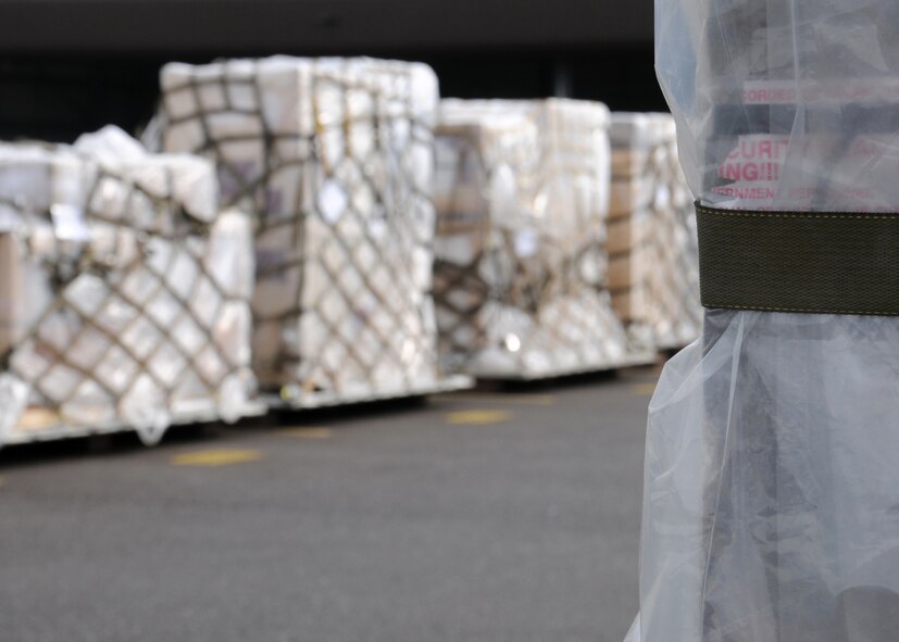 Pallets, covered in plastic to protect cargo against potential chemical attacks down-range, line the yard March 19, 2013, at RAF Mildenhall, England. Personnel from the 100th Logistics Readiness Squadron Air Transportation taught a class to 13 military members on how to safely build a pallet depending on the type of cargo and aircraft. They also educated the trainees on the documentation that must accompany a pallet to the cargo deployment function. (U.S. Air Force photo by Gina Randall/Released) 