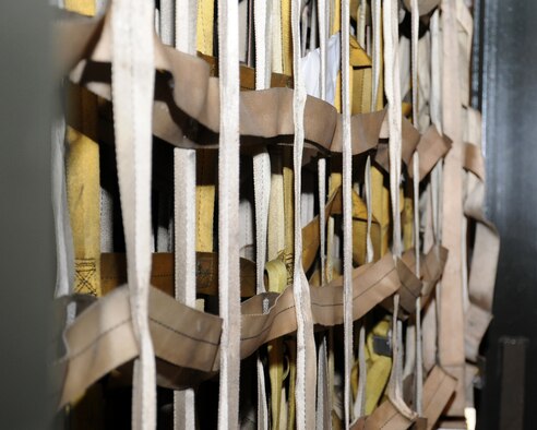 Nets are hung ready for use in the Air Mobility Command’s airlift system March 19, 2013, at RAF Mildenhall, England. A net-set consists of one top and two side nets. Before each use they must be inspected for cuts, fraying and missing hooks. During an Equipment Preparation and Pallet Build-up class, personnel learned how soft (mail or baggage), bulk (tool boxes and crated boxes) and unstable cargo (drums) are secured differently. (U.S. Air Force photo by Gina Randall/Released)  