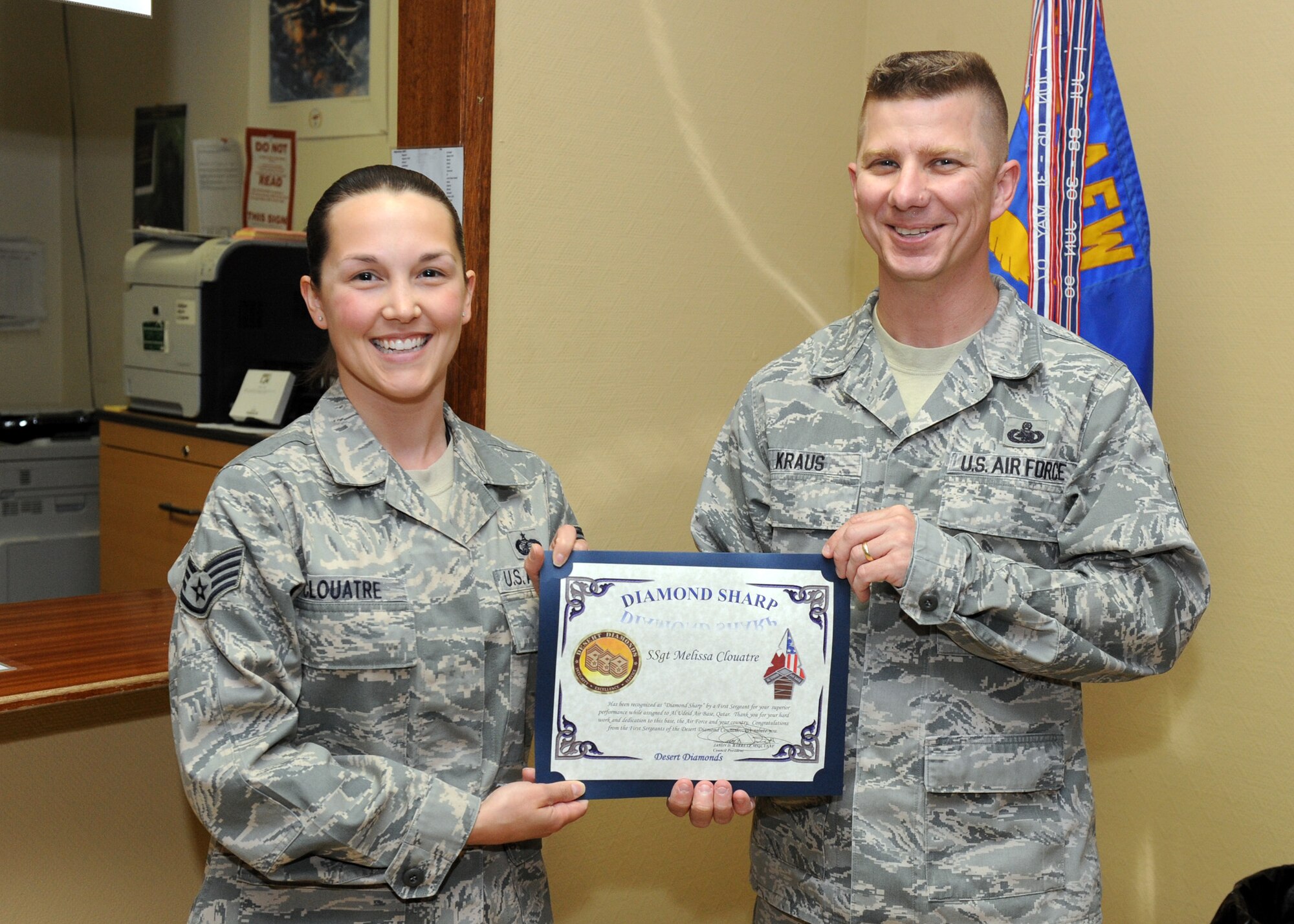 SOUTHWEST ASIA – Master Sgt. Chat Kraus, 379th Expeditionary Aircraft Maintenance Squadron first sergeant, presents Staff Sgt. Melissa Clouatre, 379th Expeditionary Comptroller Squadron, with the Diamond Sharp Award March 26. The First Sergeants of the Desert Diamond Council recently created the award to recognize Airmen for stellar performance. (U.S. Air Force photo/Senior Airman Joel Mease)