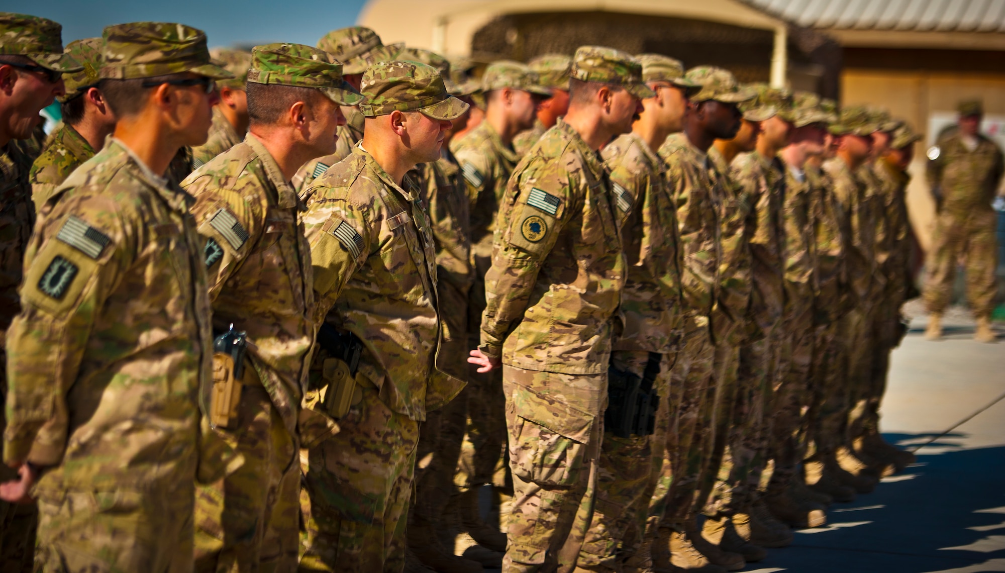 Airmen with the 777th Expeditionary Prime Base Engineer Emergency Force Squadron at Kandahar Airfield, Afghanistan, stand at ease during a ceremony in which they were transferred to the 577th EPBS, March 25, 2013. Approximately 70 people from the 777th were absorbed into the 577th. For the time being, most of the Airmen will remain at KAF, although some have been transferred to Bagram Airfield. In the future, the personnel might later be moved to other locations based on mission requirements. (U.S. Air Force photo/Senior Airman Scott Saldukas)