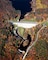 An aerial photo of the dam at Edward MacDowell Lake, taken in the fall. Edward MacDowell Dam is located on Nubanusit Brook. The dam protects Peterborough and other communities downstream and is part of five flood control dams in the Merrimack River Basin.