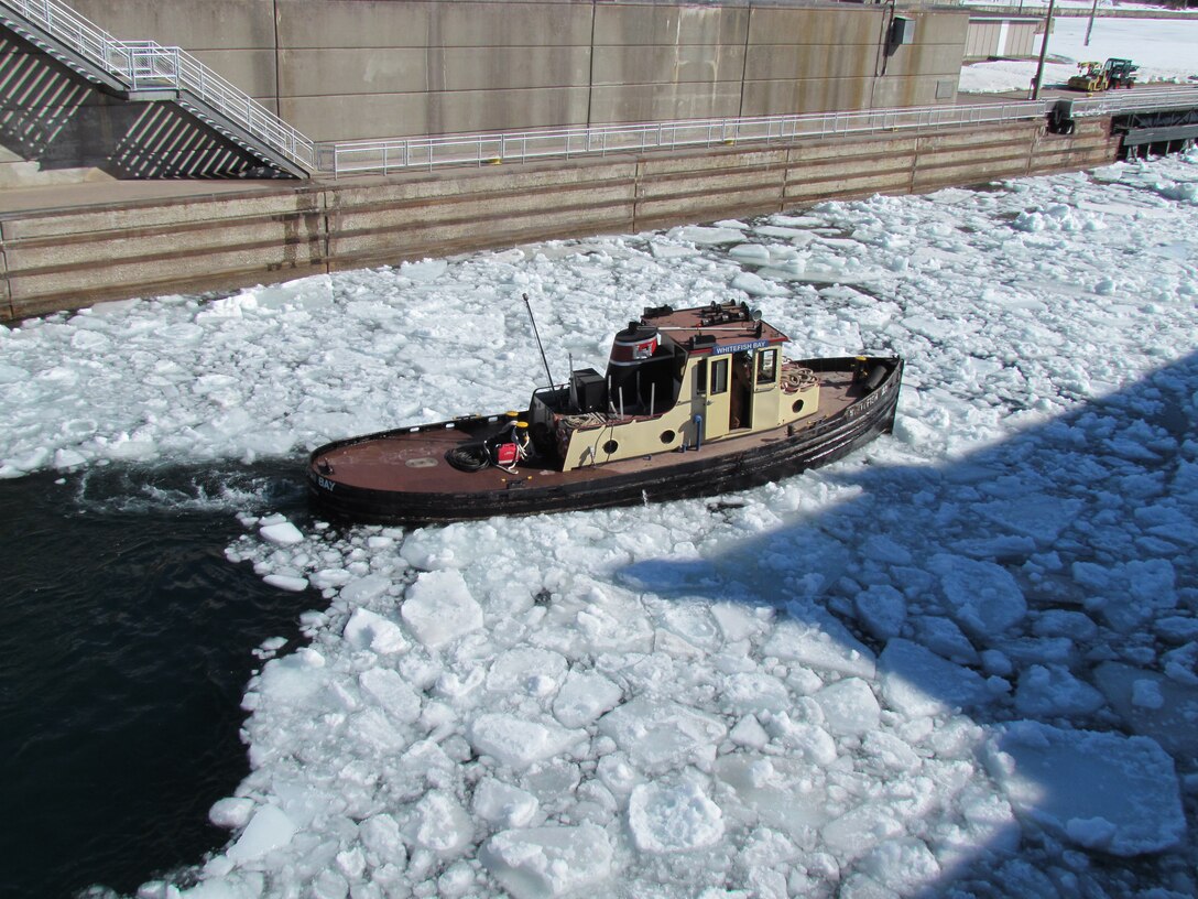 The U.S. Army Corps of Engineers tug Whitefish Bay works to clear a large field of ice out of the lower end of the Poe Lock