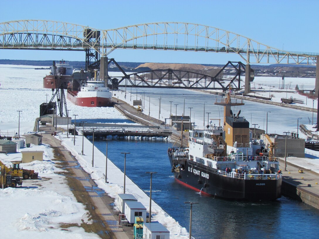 The downbound Frontenac and Paul R. Tregurtha wait at the pier for the upbound U.S. Coast Guard Cutter Alder at the Soo Locks, March 28.