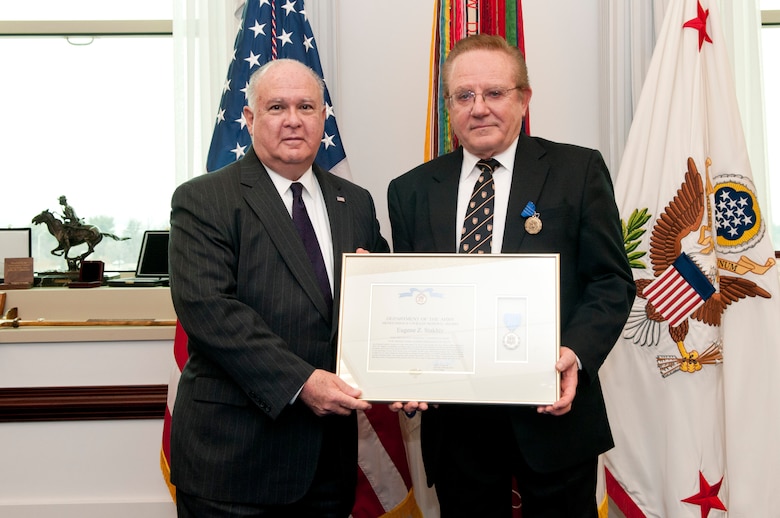 Under Secretary of the Army Dr. Joe Westphal (left) presents medal to Dr. Eugene Stakhiv (right).