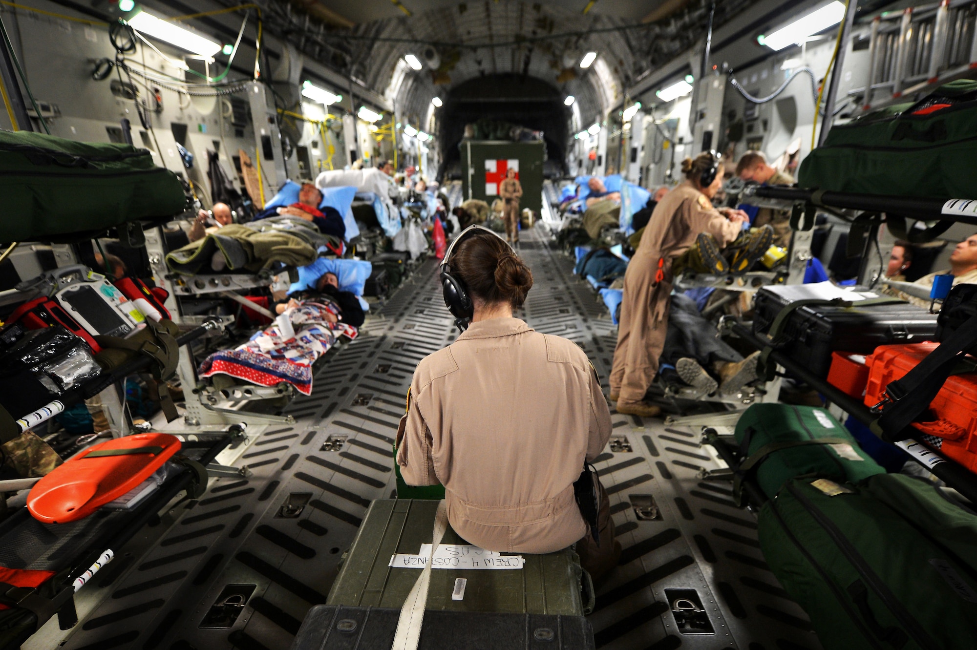 Members of the of a 455th Expeditionary Aeromedical Evacuation Squadron Critical Care Air Transport Team assist patients on a C-17 Globemaster III medical transport flight, out of Bagram Airfield, Afghanistan, March 21, 2013. Air Force Medicine is expanding aeromedical evacuation and CCATT capacity as it prepares to deliver medical support in future conflicts. (U.S. Air Force photo by Senior Airman Chris Willis)