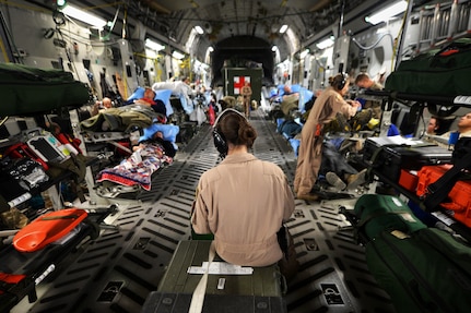 Members of the of a 455th Expeditionary Aeromedical Evacuation Squadron Critical Care Air Transport Team assist patients on a C-17 Globemaster III medical transport flight, out of Bagram Airfield, Afghanistan, March 21, 2013. Air Force Medicine is expanding aeromedical evacuation and CCATT capacity as it prepares to deliver medical support in future conflicts. (U.S. Air Force photo by Senior Airman Chris Willis)