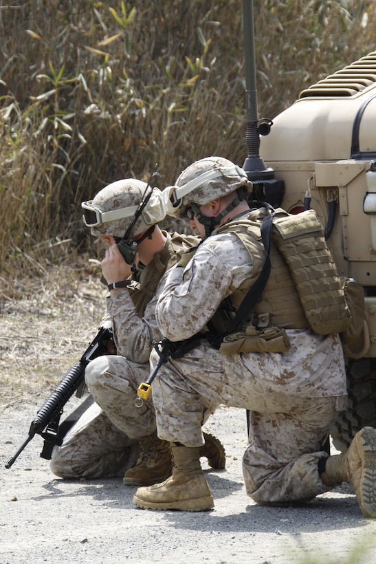 Cpl. Robert Kent (left), Marine Wing Support Squadron 171 bulk-fuel specialist, and 1st Lt. James Woolley, MWSS-171 combat engineer platoon commander and exercise security team leader, radio in a possible improvised explosive device during an afternoon convoy patrol in the Haramura training area as part of Exercise Thunder Horse, March 19, 2013.