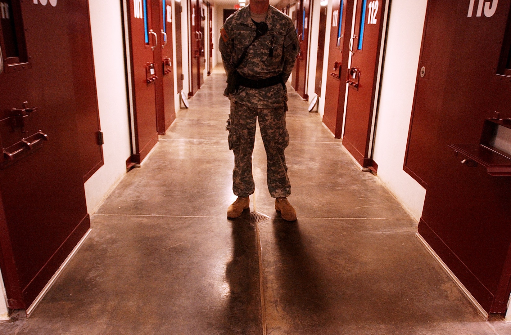 A Soldier stands guard on a cell block inside Camp Five at the Joint Task Force Guantanamo detention center at Naval Base Guantanamo Bay, Cuba, Nov. 14, 2006. Camp Five is one of six camps that comprise the dentention center, and has been built with many features that can be found in many maximum security prisons in the United States. Camp Five is where the most non-compliant and hostile detainees are held. ( Photo by                                                           