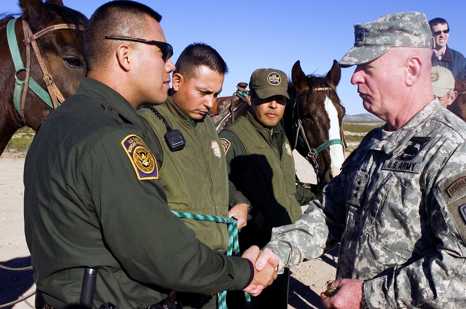 Lt. Gen. H Steven Blum, chief, National Guard Bureau, talks with Border Patrol agents during a visit to the U.S. border with Mexico near Columbus, N.M., on Nov. 29, 2006. Up to 6,000 National Guard troops are helping the Border Patrol secure the nation's southern border in Operation Jump Start.