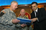 Maj. Gen. John Libby, adjutant general of the Maine National Guard, and LTG H Steven Blum, chief of the National Guard Bureau, present a book about Maine to Montenegrin President Filip Vujanovic in Podgorica, Montenegro, on Dec. 7, 2006. The Maine National Guard and Montenegro formally announced their pairing in the National Guard’s State Partnership Program on Dec. 7.
