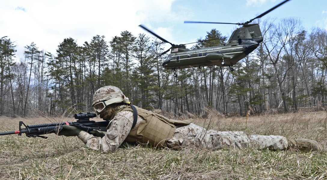 Lance Cpl. Austin Daniels, travel clerk, gets in the prone position and provides security during a Finance Section Field Operation at the landing zone “Thrush” aboard Marine Corps Base Quantico on March 27, 2013. Several of the Marines that participated in the operation had never flown in a CH-46E "Sea Knight” aircraft before.