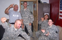 Soldiers from the 1744th Transportation Company celebrate as Chicago Bear Bernard Berrian catches a touchdown pass from quarterback Rex Grossman in the Chicago Bears' victory over the New Orleans Saints in the National Football Conference Championship game, Jan. 21. Pictured are: Spc Daniel Barsi (front left raising his fist in the air), Staff Sgt. Joseph Geymayel (back left), Spc. Kyle Hollingsworth (in the doorway), Spc. Annette Uriostegui (back right), and Spc. Brianna Mariani.