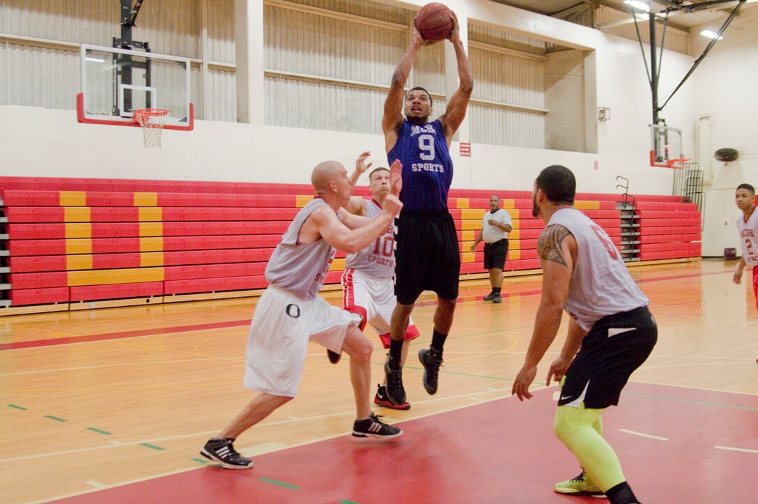 MARINE CORPS BASE HAWAII - Headquarters Battalion player Marcus Martin takes a shot during the championship game for the intramural basketballseason at the Semper Fit Center gym, March 27, 2013. The intramural basketball season came to a close with a brutal tug of war between Headquarters Bn. and Postal, resulting in Headquarters Bn.’s win, 43-37. (U.S. Marine Corps photo by Kristen Wong)