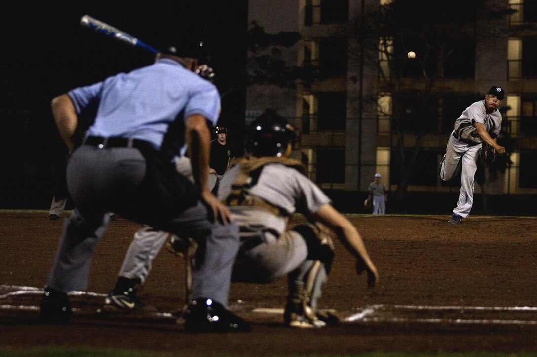 MARINE CORPS BASE HAWAII - The Kings of Battle pitcher hurls the ball to a Golden Eagles batter during a game between the Golden Eagles and the Kings of Battle at Riseley Field, March 25. Both teams were missing key players throughout the game, but each team played hard, resulting in a very close game. (U.S. Marine Corps photo by Lance Cpl. Matthew Bragg)