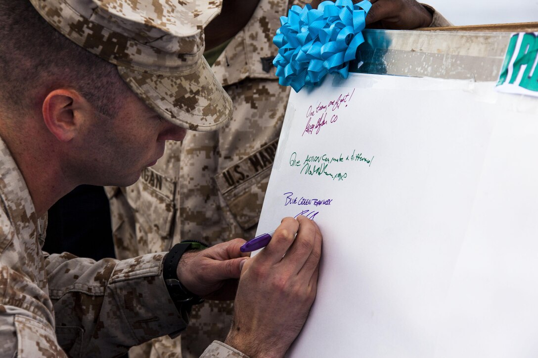 Capt. Raymond Kaster, a Bridgewater, N.J, native and commanding officer, Company K, Battalion Landing Team 3/2, 26th Marine Expeditionary Unit (MEU), is the first Marine to pledge to intervene in support of Sexual Assault Awareness Month aboard the USS Carter Hall (LSD 50) while at sea March 28, 2013. Co. K and Combat Logistics Battalion 26, 26th MEU, had more than 100 Marines in attendance. The 26th MEU is currently deployed to the 6th Fleet area of operation. The MEU operates continuously across the globe, providing the president and unified combatant commanders with a forward-deployed, sea-based quick reaction force. The MEU is a Marine Air-Ground Task Force capable of conducting amphibious operations, crisis response, and limited contingency operations.
(U.S. Marine Corps photo by Staff Sgt. Edward Guevara/Released)