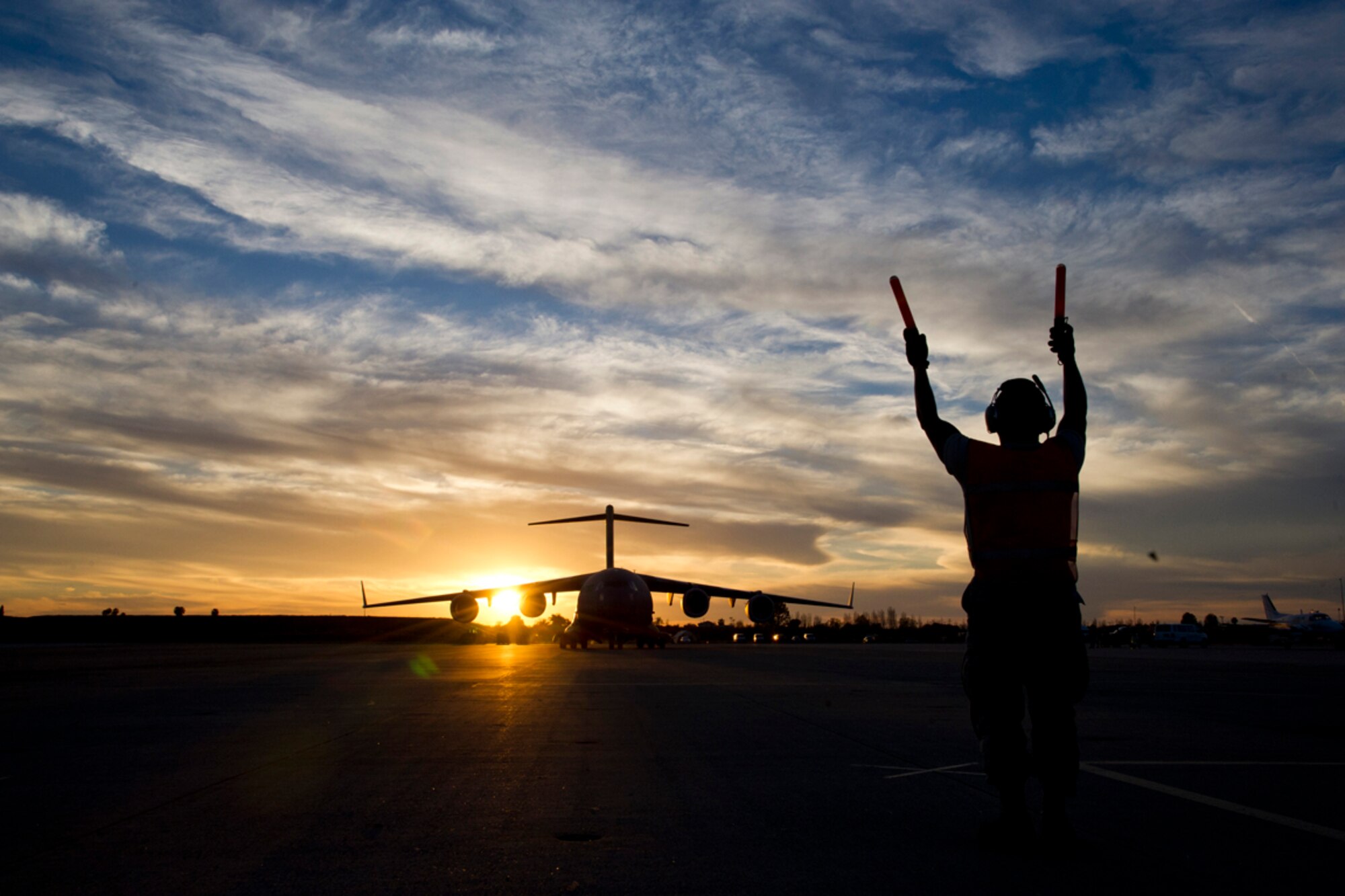 An Airman marshals a C-17 Globemaster III during Patriot Hook 2013 at Los Alamitos Army Airfield in Los Alamitos, Calif., March 14, 2013. Patriot Hook is an annual exercise that simulates a response by a joint military and civilian force to a natural disaster in a forward-deployed location. (U. S. Air Force photo by Staff Sgt. Heather Cozad) 