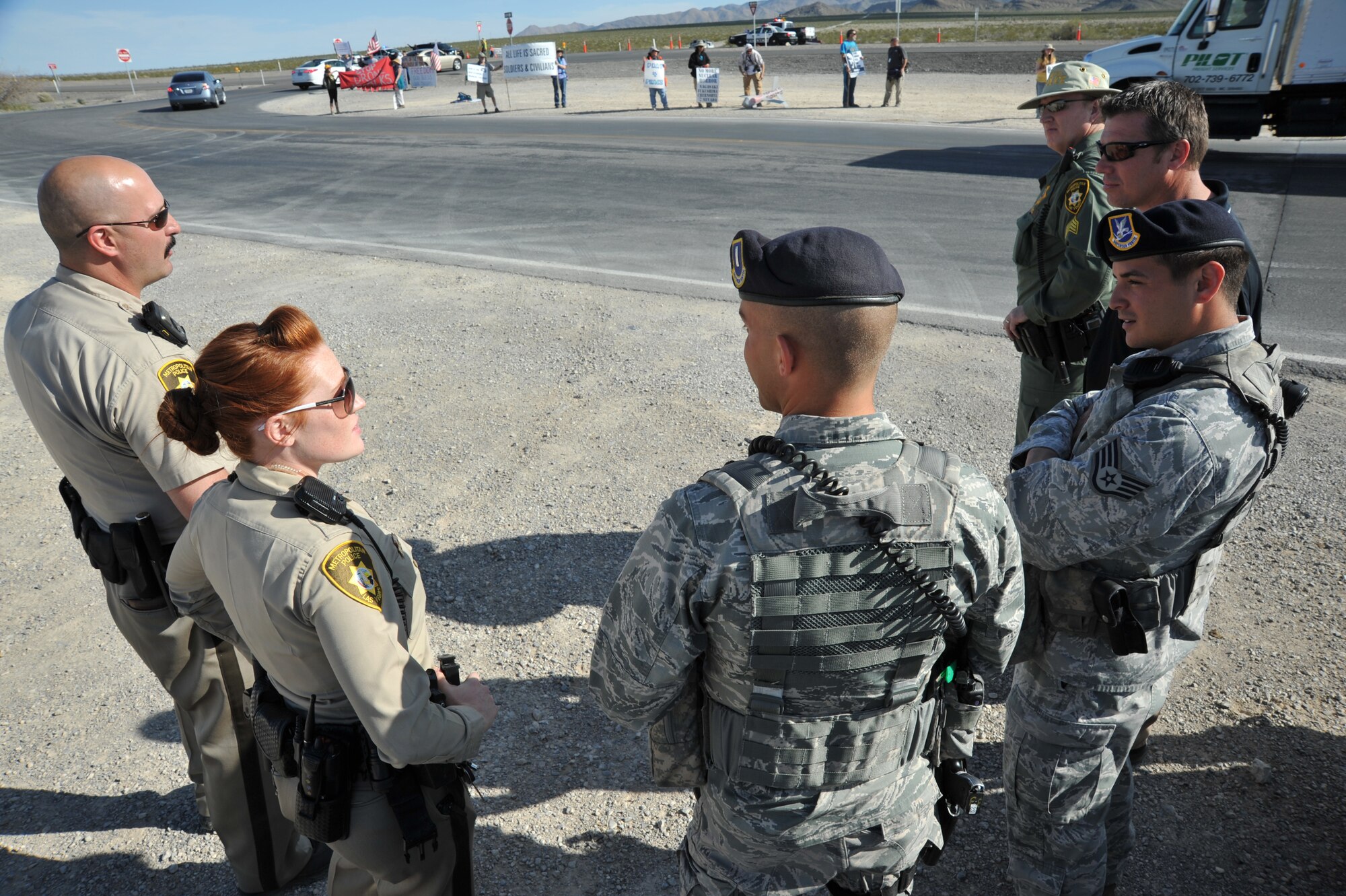 INDIAN SPRINGS, Nev. – 799th Security Forces Squadron and local law enforcement discuss lessons learned during a protest, March 29, 2013. Military and civilian law enforcement agencies partner together to help ensure the safety of Airmen while also protecting the First Amendment rights of U.S. citizens. (U.S. Air Force photo by Senior Master Sgt. P.H./Released)