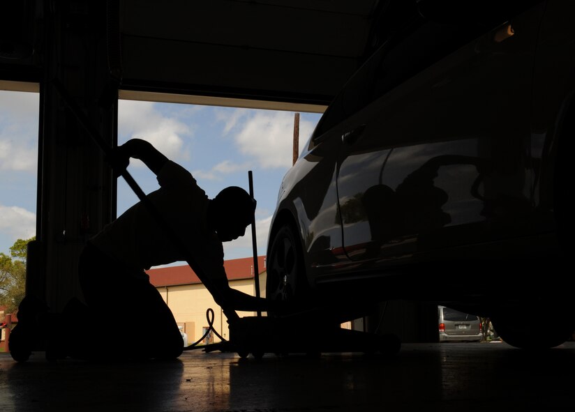 Senior Airman Wendell Moore, 2nd Aircraft Maintenance Squadron crew chief, lifts his vehicle at the Auto Hobby Shop on Barksdale Air Force Base, La., March 29. The shop gives base personnel a place to work on their vehicles and provides all the essential tools. (U.S. Air Force photo/Airman 1st Class Benjamin Gonsier)
