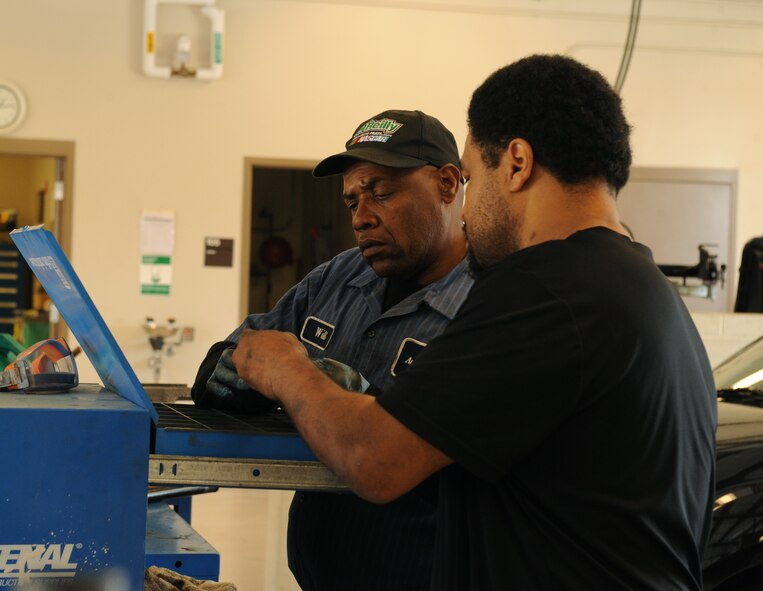 Will Young, left, Auto Hobby Shop, and Retired Master Sgt. Andre Cook, 49th Test and Evaluation Squadron, look for a piece of equipment at the Auto Hobby Shop on Barksdale Air Force Base, La., March 29. The shop gives base personnel a place to work on their vehicles and provides all the essential tools. (U.S. Air Force photo/Airman 1st Class Benjamin Gonsier)