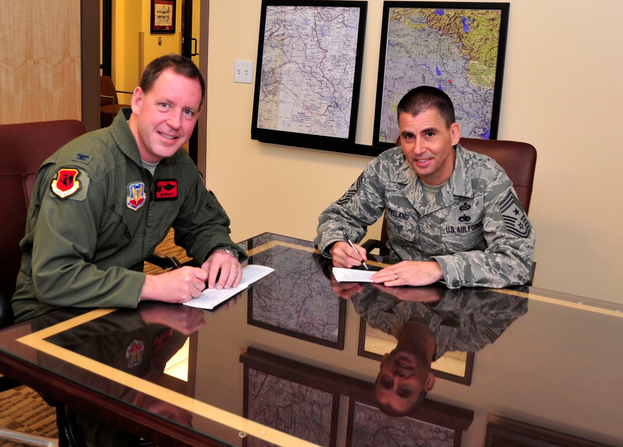 LAS VEGAS, Nev. -- 432d Wing, 432d Air Expeditionary Wing leadership sign donation forms, kicking off the annual Air Force Assistance Fund campaign. The purpose of the six-week campaign is to raise funds for Airmen, widows and widowers in need of financial assistance.  (U.S. Air Force photo by Senior Airman A.K./Released)